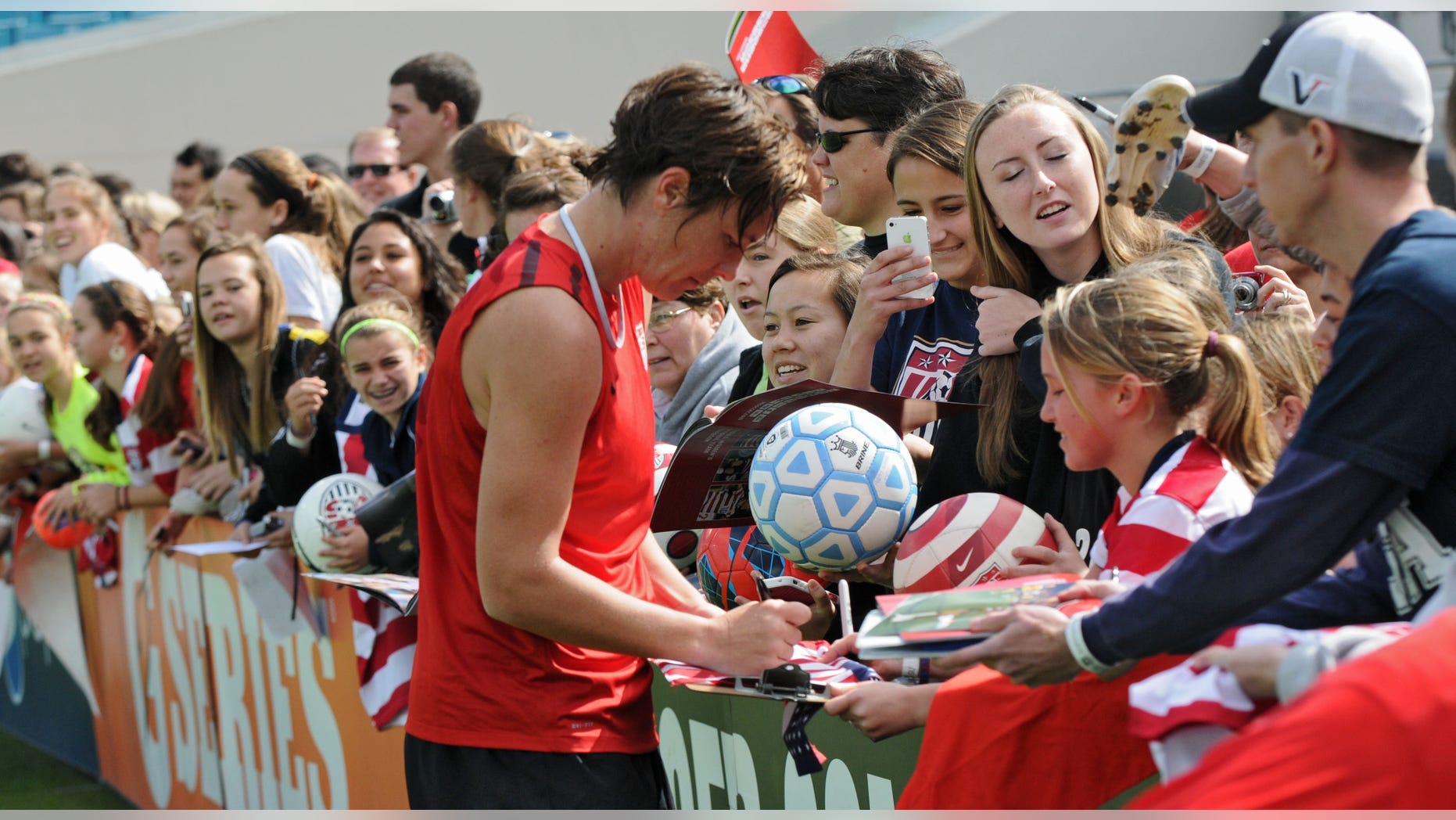 Abby Wambach signs autographs for fans after the U.S. women's soccer team practiced in Jacksonville, Fla., on Friday, Feb. 8, 2013. The practice was open to the public, and several hundred people attended. (AP Photo/The Florida Times-Union, Bob Mack)