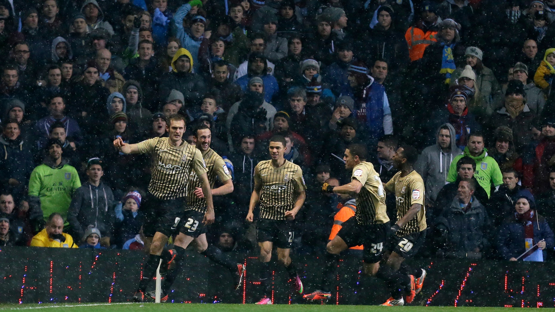 Bradford City' James Hanson, left, celebrates with teammates after scoring a goal against Aston Villa during their English League Cup second leg semi-final soccer match at Villa's stadium in Birmingham, England, Tuesday, Jan. 22, 2013.(AP Photo/Alastair Grant)