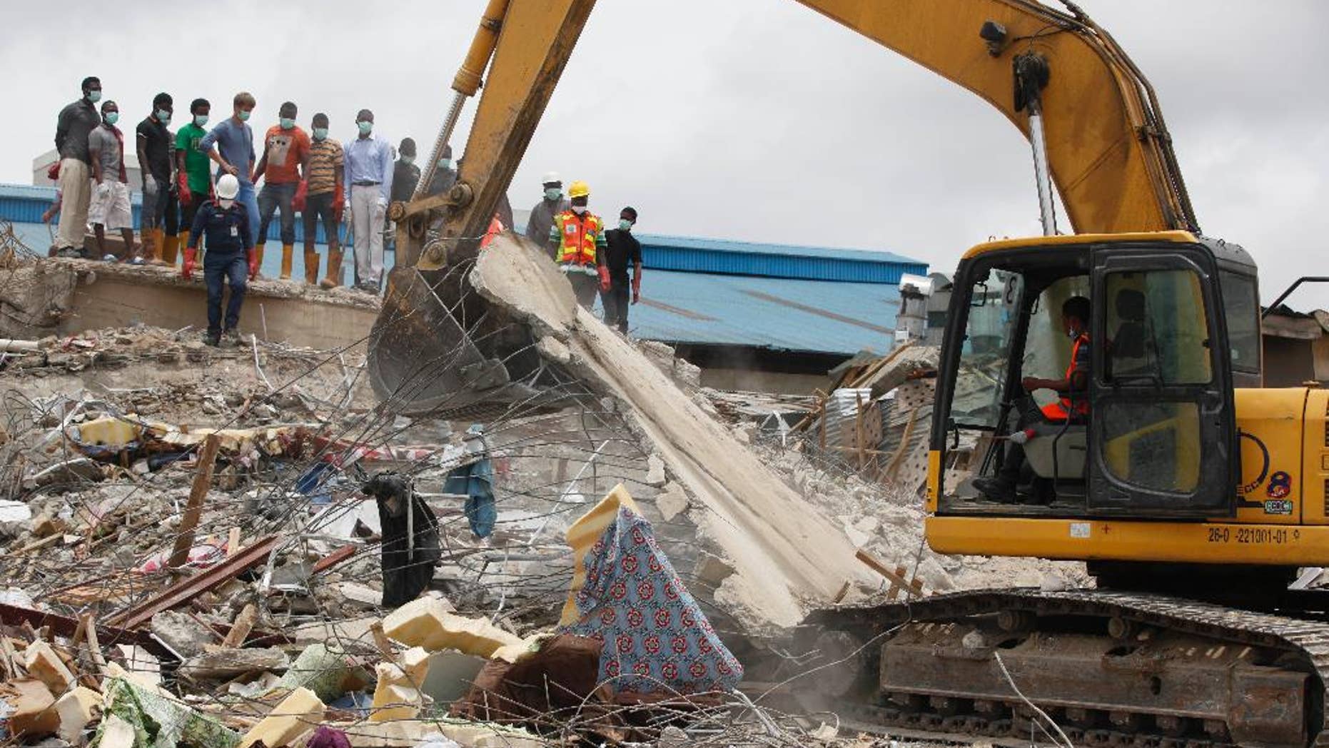 FILE - In this Wednesday, Sept. 17, 2014 file photo, rescue workers search for survivors in the rubble of a collapsed building belonging to the Synagogue Church of All Nations in Lagos, Nigeria. The Synagogue Church of All Nations of televangelist T. B. Joshua on Thursday, July 9, 2015 rejected a coroner’s report recommending prosecution of the Nigerian church and two structural engineers in the collapse of a church building that killed 116 people, most of them visitors from South Africa. (AP Photo/Sunday Alamba, File)
