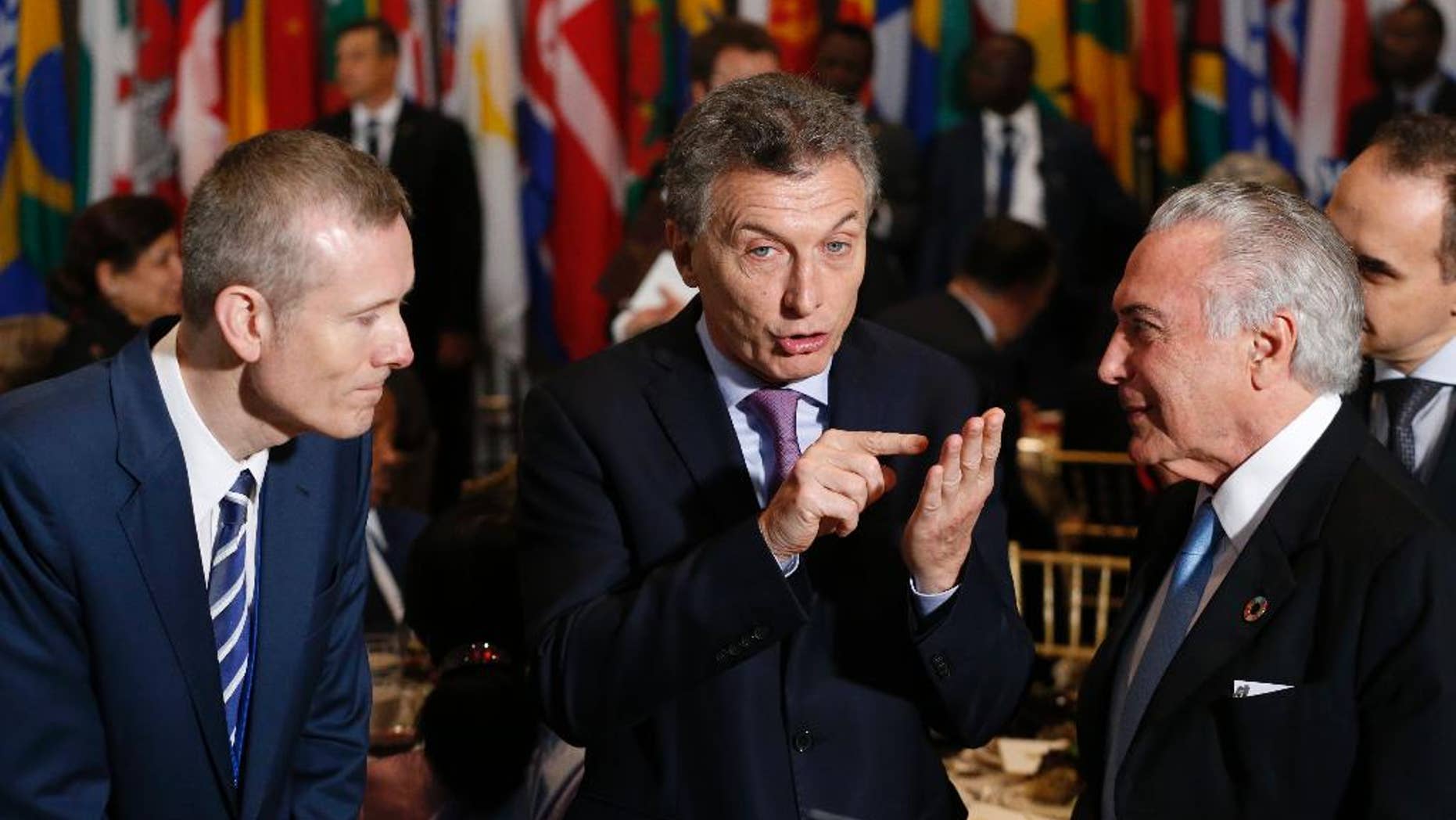 Argentina's President Mauricio Macri, center, speaks with Brazil's President Michel Temer, right, as they arrive for a luncheon during the United Nations General Assembly at United Nations headquarters Tuesday, Sept. 20, 2016. (Lucas Jackson/Pool Photo via AP)