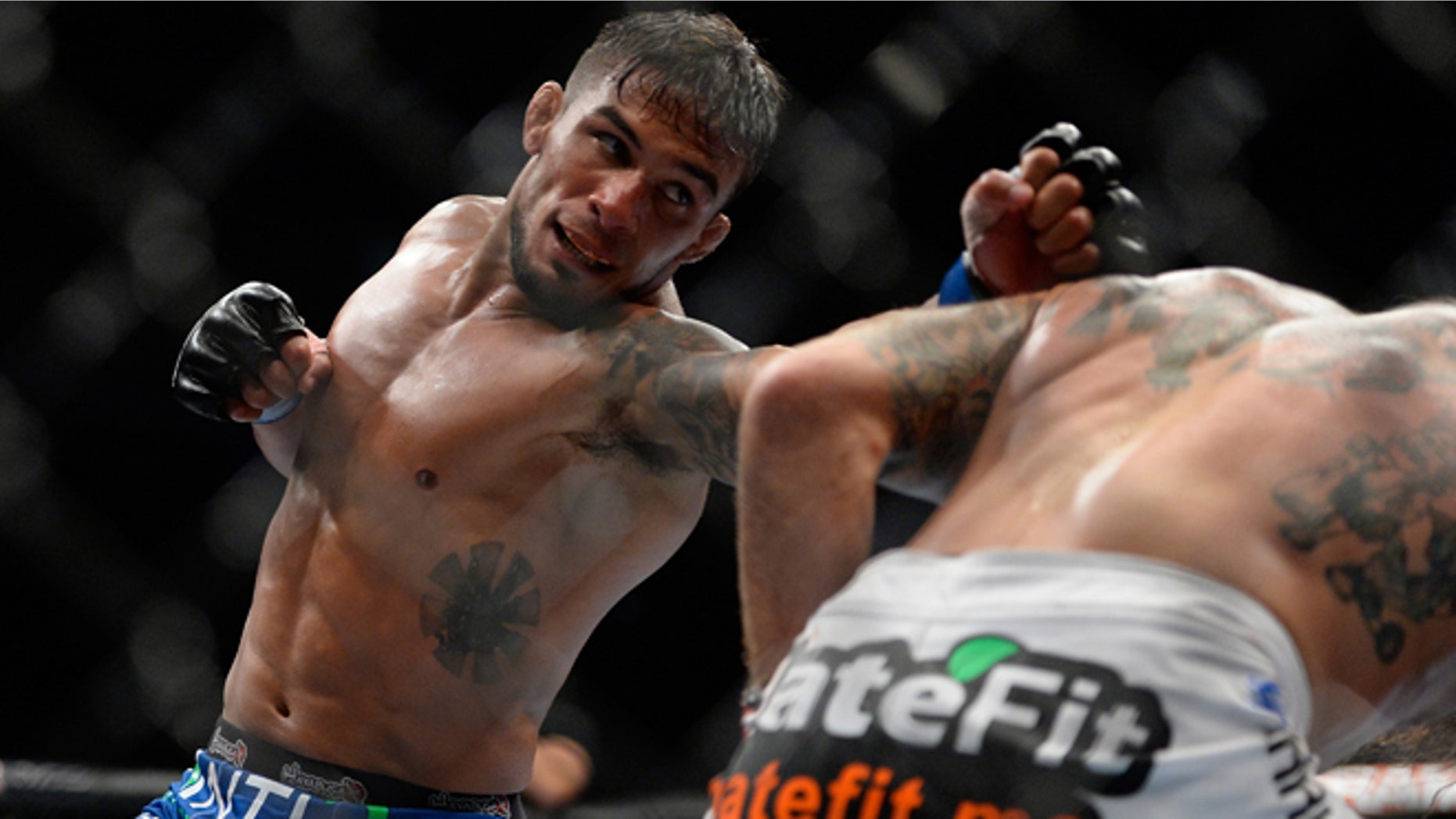 SAN JOSE, CA - JULY 26: (L-R) Dennis Bermudez punches Clay Guida in their featherweight bout during the UFC Fight Night event at the SAP Center on July 26, 2014 in San Jose, California. (Photo by Jeff Bottari/Zuffa LLC/Zuffa LLC via Getty Images)