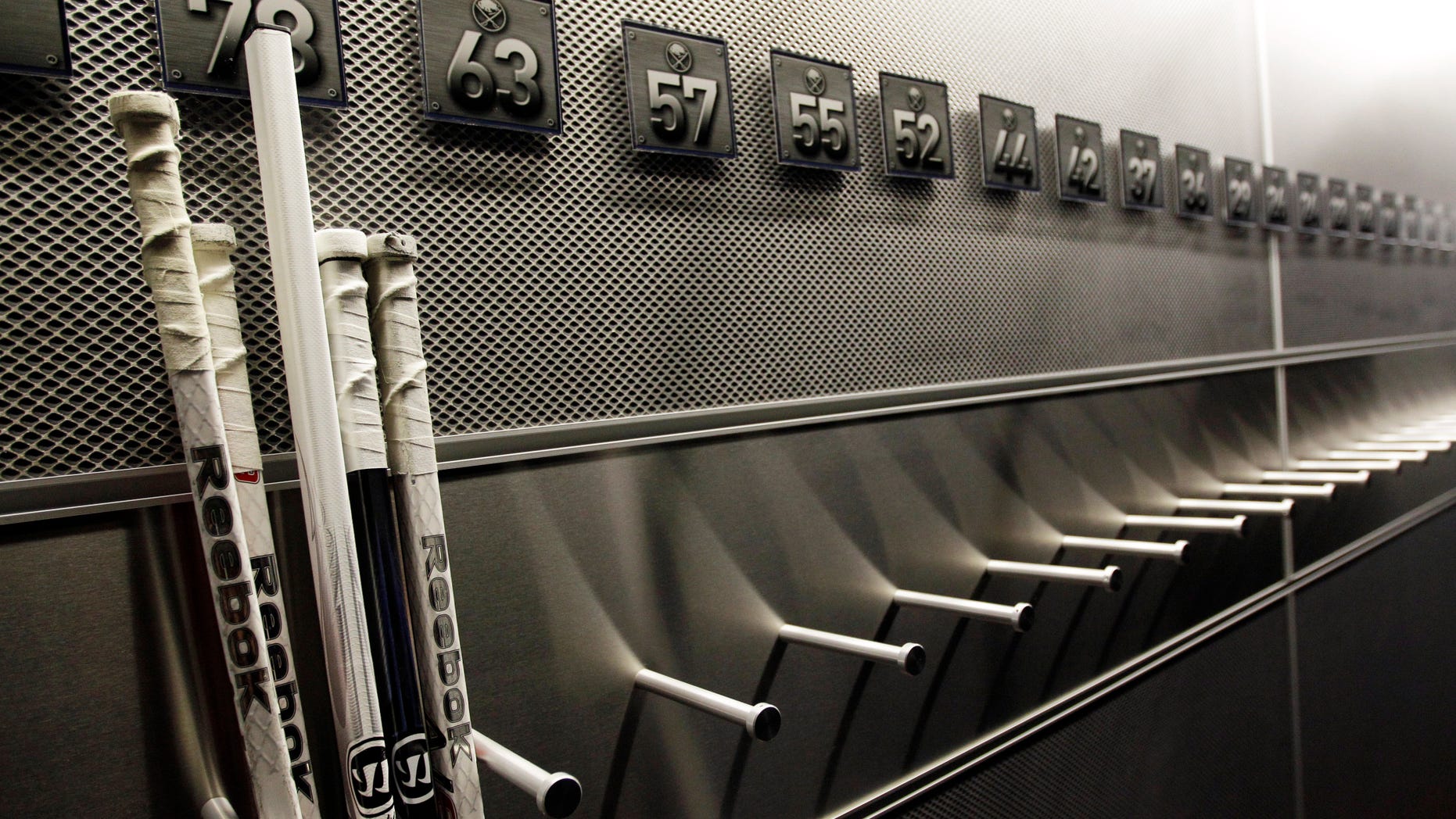 FILE - In this Sept. 25, 2012 file photo, a nearly empty hockey stick rack in the locker room of the Buffalo Sabres hockey team is shown during the NHL labor lockout in Buffalo, N.Y. The NHL lockout that's already wiped out the first three months of the season is taking its toll on Buffalo businesses. And it's no different in many of the NHL's 29 other markets. (AP Photo/David Duprey, File)