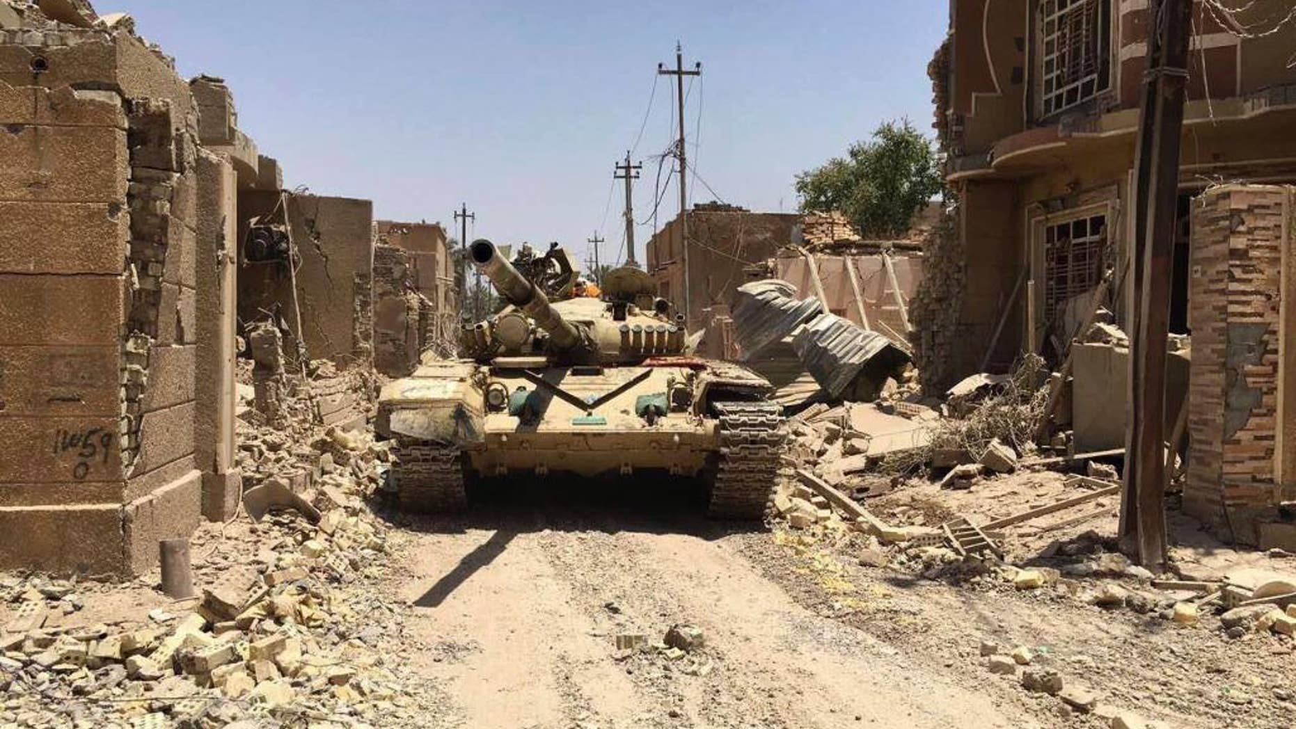 Iraqi security forces in al-Julan neighborhood after defeating Islamic State militants in Fallujah, Iraq, Sunday, June 26, 2016. A senior Iraqi commander said the city of Fallujah was "fully liberated" from Islamic State militants on Sunday, after a more than monthlong military operation. (AP Photo)