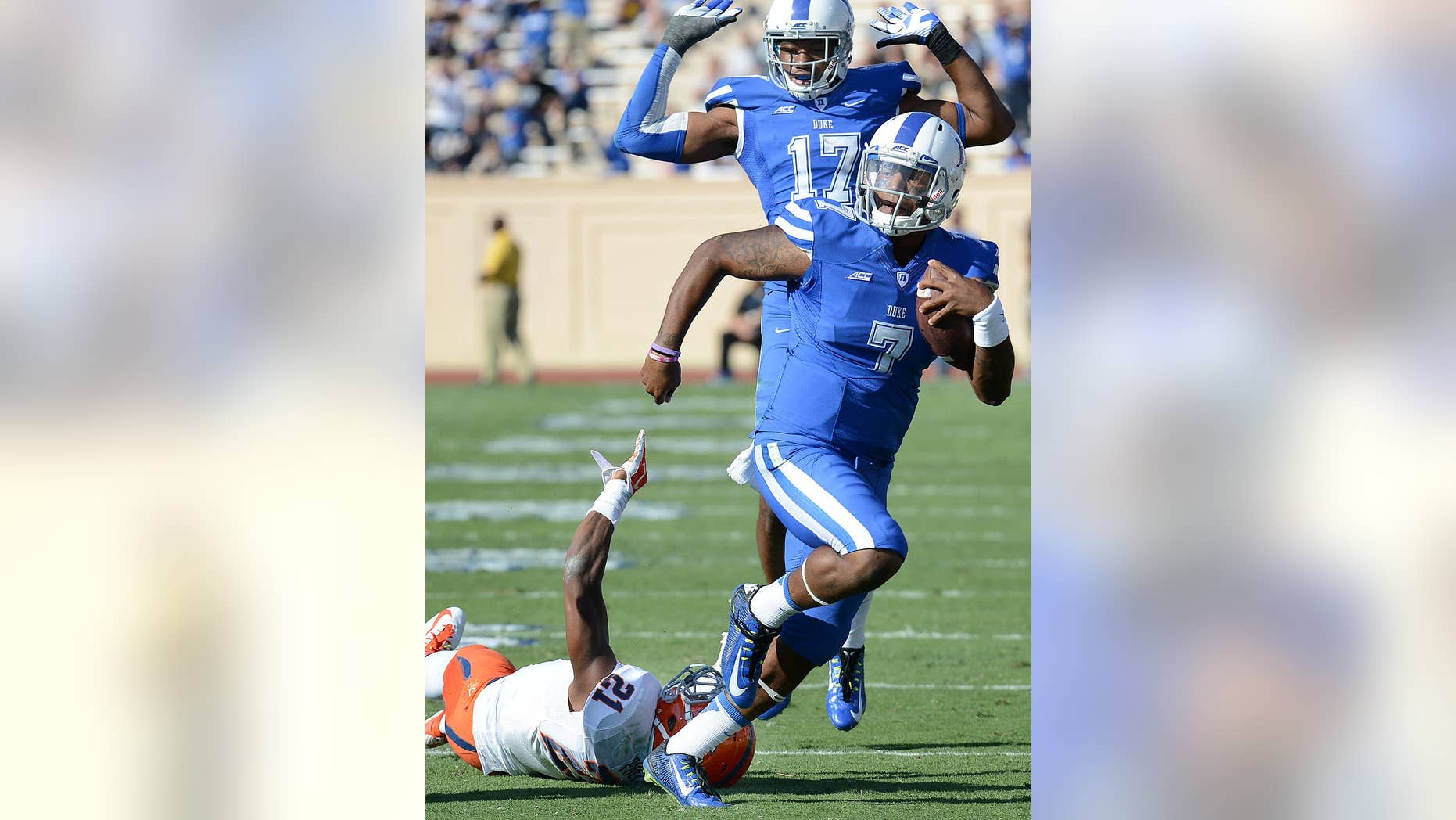 FILE - In this Oct. 18, 2014, file photo, Duke quarterback Anthony Boone (7) runs past Virginia's Brandon Phelps (21) for a first down during an NCAA college football game in Durham, N.C. Maybe Duke really wasn't a one-year wonder in 2013. (AP Photo/The Herald-Sun, Bernard Thomas, File)