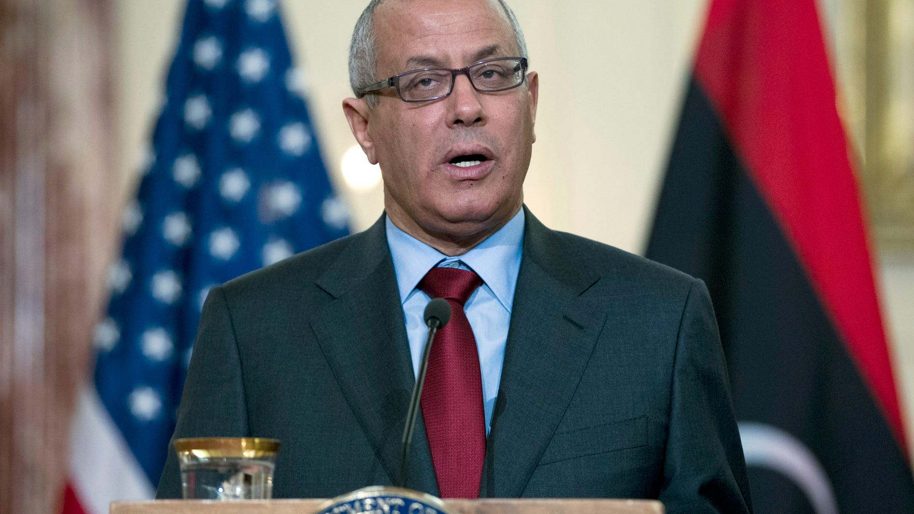 FILE - In this March 13, 2013 file photo, Libyan Prime Minister Ali Zidan speaks during a joint news conference with U.S. Secretary of State John Kerry at the State Department in Washington. Libya's parliament passed a law on Sunday, May 5, 2013, that bans officials who held senior positions under ousted dictator Moammar Gadhafi from holding high-level government posts, a move that could disqualify much of the country's political elite from office including Prime Minister Ali Zidan, who served as a diplomat under Gadhafi. (AP Photo/Jose Luis Magana, File)