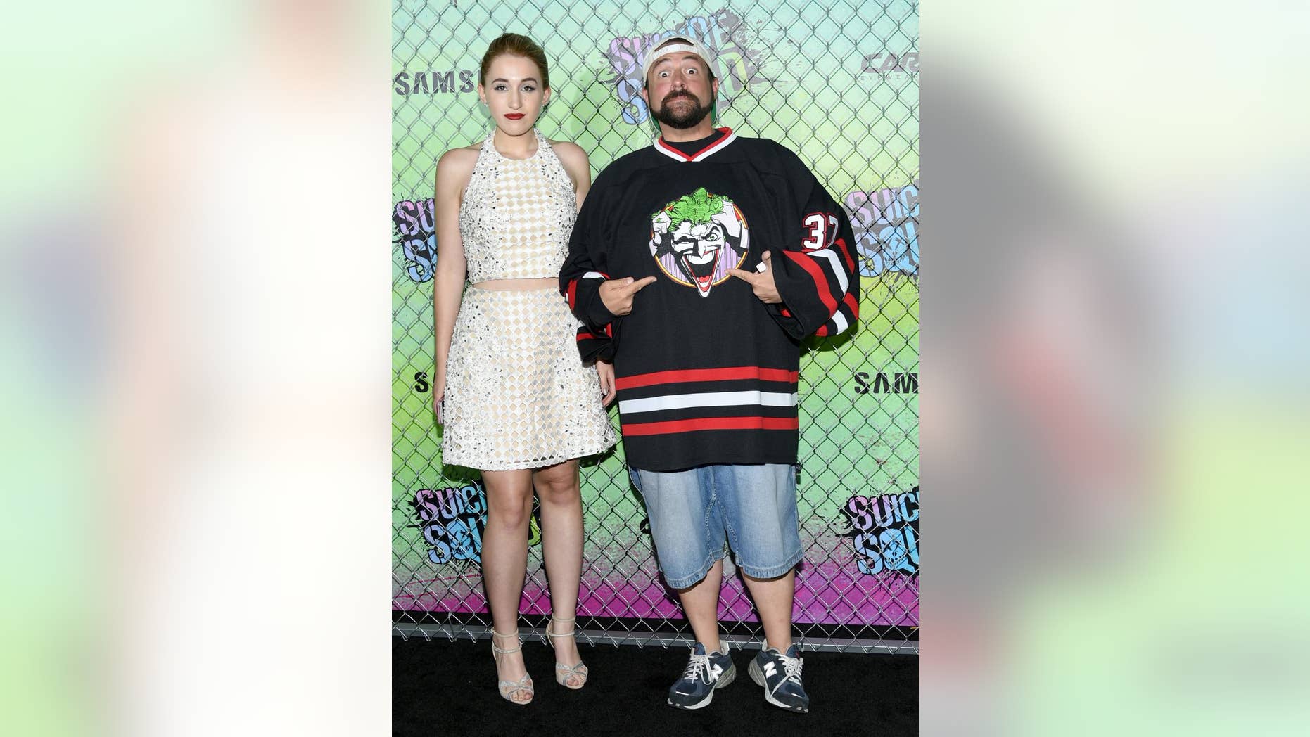 FILE - In this Aug. 1, 2016, file photo, Harley Quinn Smith, left, and her father, Kevin Smith, attend the world premiere of "Suicide Squad" at the Beacon Theatre in New York. Kevin Smith took to Facebook on Aug. 15, 2016, to slam an online troll for criticizing his daughter. (Photo by Evan Agostini/Invision/AP, File)