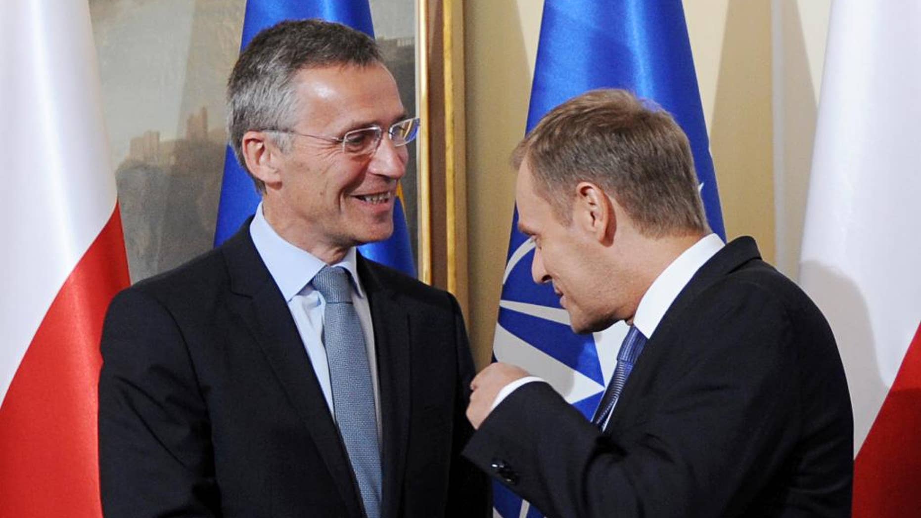 Polish Prime Minister Donald Tusk, right, gestures, as he meets NATO Secretary General designate Jens Stoltenberg, prior to talks in Warsaw, Poland, Wednesday, June 25, 2014. (AP Photo/Alik Keplicz)