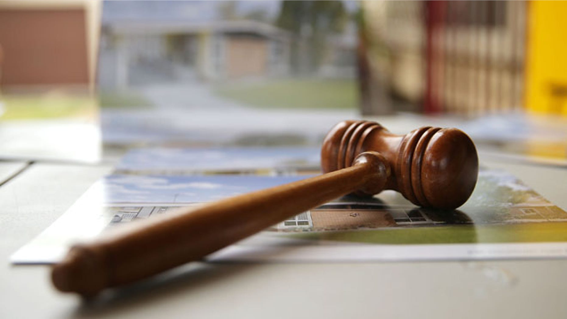 BLACKTOWN, AUSTRALIA - FEBRUARY 14: An auctioneer's gavel is seen prior to the home auction for a four-bedroom house at 230 Blacktown Road on February 14, 2015 in Blacktown, Australia. The Blacktown home sold for AUD$565,000 at auction today, smashing the reserve set at AUD$1. The Sydney home auction clearance rate is expected to remain high following the Reserve Bank's interest rate cut to 2.25 per cent last week. (Photo by Mark Metcalfe/Getty Images)