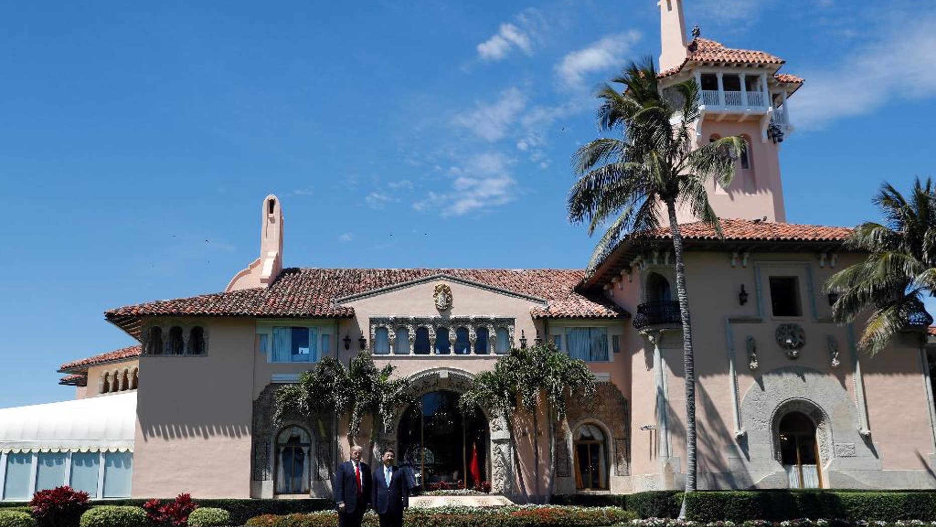 President Donald Trump, left, and Chinese President Xi Jinping pause in their walk after their meetings at Mar-a-Lago, Friday, April 7, 2017, in Palm Beach, Fla. (AP Photo/Alex Brandon)