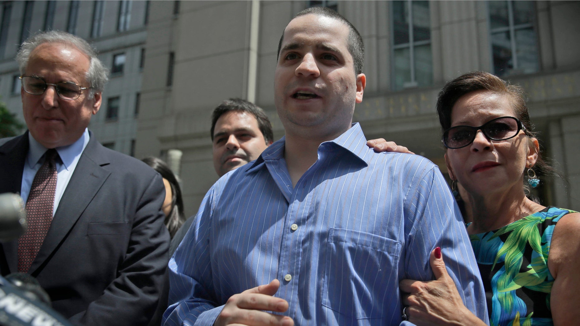 FILE - In a Tuesday, July 1, 2014 file photo, GIlberto Valle, center, acquitted in a conspiracy to kidnap, kill and eat women, makes a statement to the media as he leaves Manhattan federal court in New York. Prosecutors said in a pre-sentencing memorandum filed Tuesday, Oct. 28, 2014, that one year of supervised release is sufficient for Valleâs conviction for unlawfully accessing a federal database. Valle will be sentenced next week. Valle's mother, Elizabeth Valle is at right. (AP Photo/Seth Wenig, File)