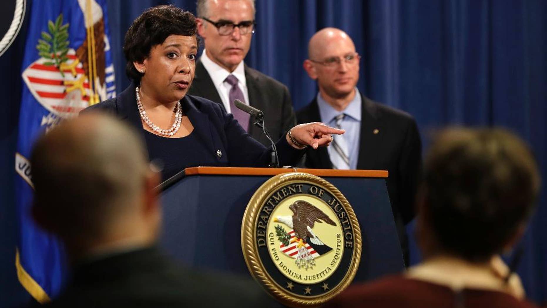 Attorney General Loretta Lynch, left, next to FBI Deputy Director Andrew McCabe and IRS Criminal Division Chief Richard Weber, speaks at a news conference, Wednesday, July 20, 2016, at the Justice Department in Washington, announcing that the U.S. government is seeking the forfeiture of more than $1 billion in assets that federal officials say were misappropriated from a Malaysian sovereign wealth fund. (AP Photo/Jacquelyn Martin)