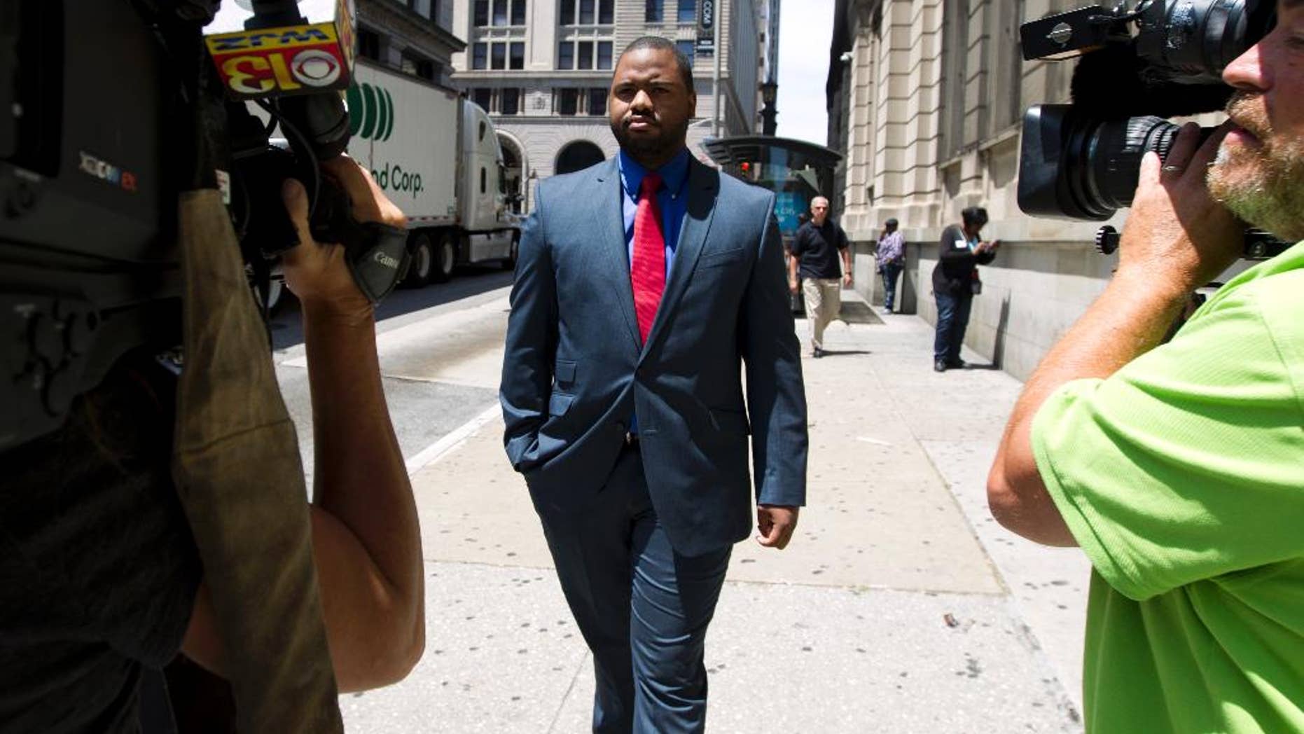 Baltimore police Officer William Porter, one of six Baltimore city police officers charged in connection to the death of Freddie Gray, leaves the courthouse, after testifying in the trial of Officer Caesar Goodson, Monday, June 13, 2016, in Baltimore Md. Porter's trial in the Gray case ended in mistrial. He will be tried again in September. (AP Photo/Jose Luis Magana)