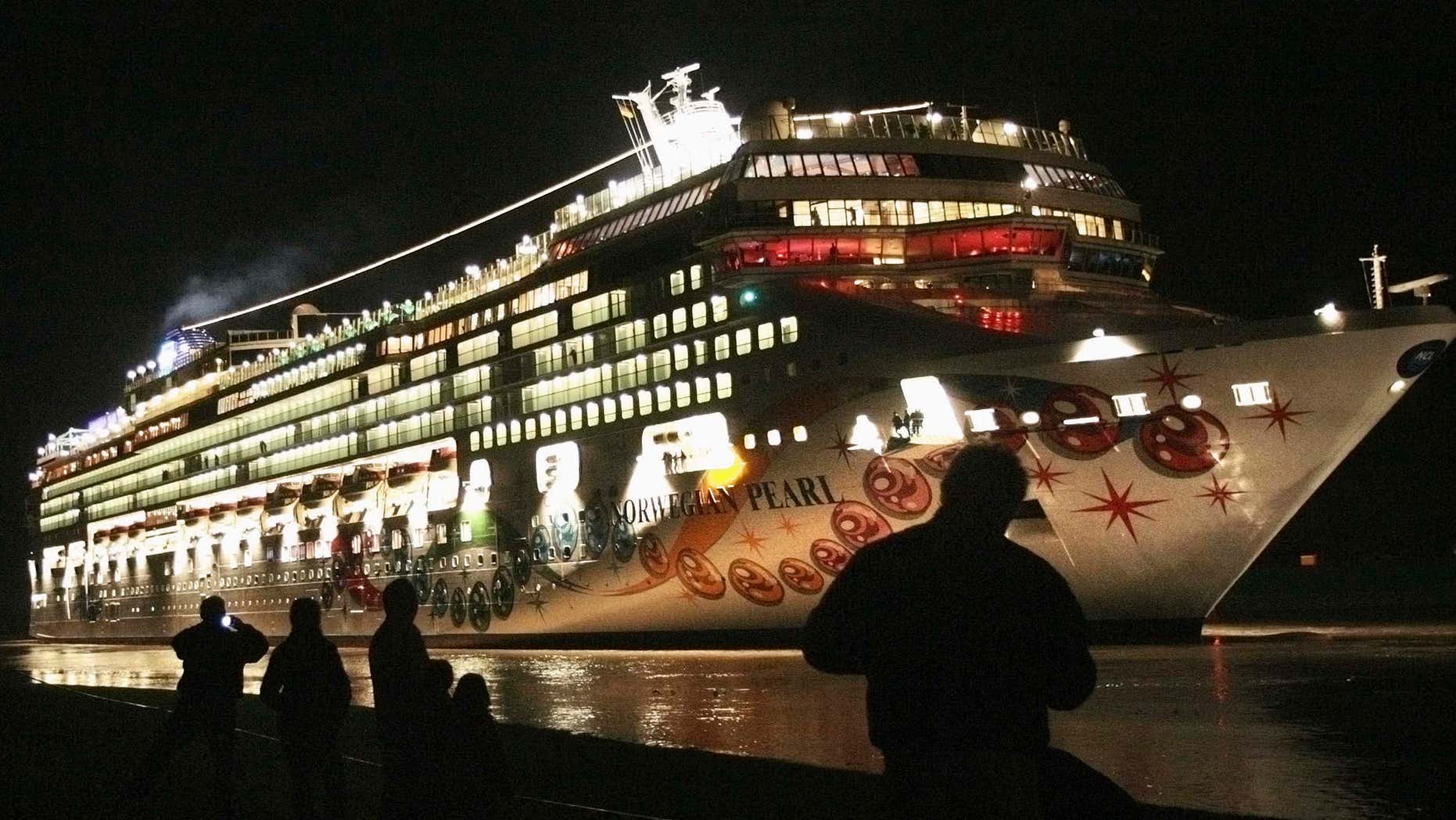 Nov. 7, 2006: People stand on a dyke watching the newly built cruise ship 'Norwegian Pearl' on its passage from the Meyer shipyard in Papenburg to the North Sea.