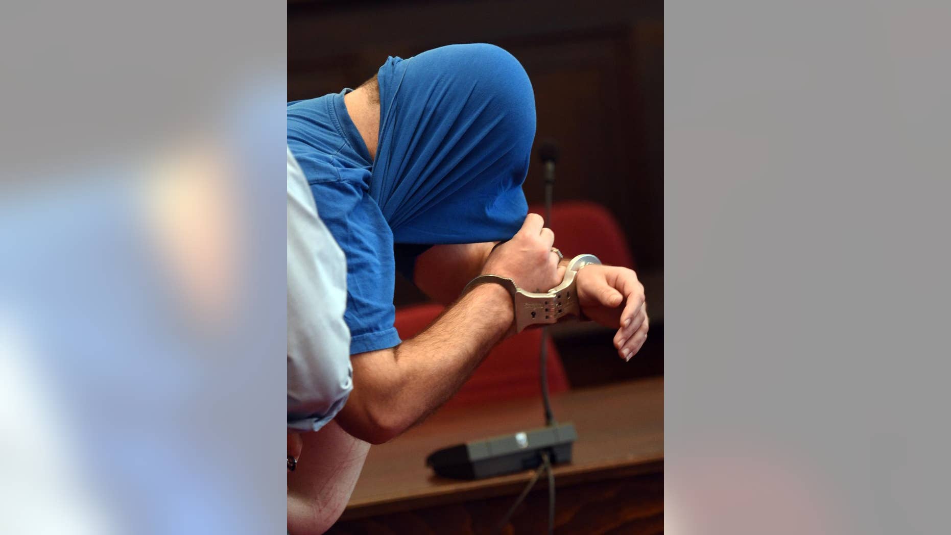 FILE - In this Sept. 20, 2016 file picture accused Syrian Hassan Z. sits in a courtroom before the start of his trial in Bonn, Germany. The Syrian asylum-seeker has been convicted of three counts of attempted murder for throwing his children out of the window of a refugee home in Germany. He was sentenced to 15 years in prison. The dpa news agency says the 35-year-old Syrian was convicted Thursday Nov. 3, 2016 at the Bonn state court. (Henning Kaiser/dpa via AP)