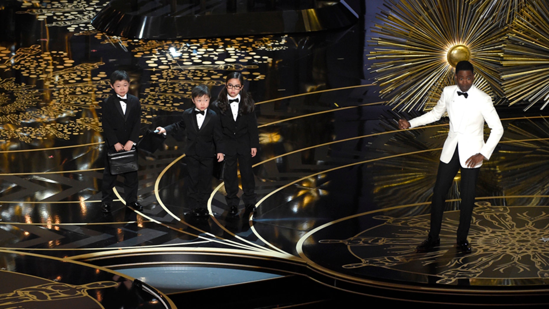 Host Chris Rock, right, and children participate in a skit at the Oscars on Sunday, Feb. 28, 2016, at the Dolby Theatre in Los Angeles.