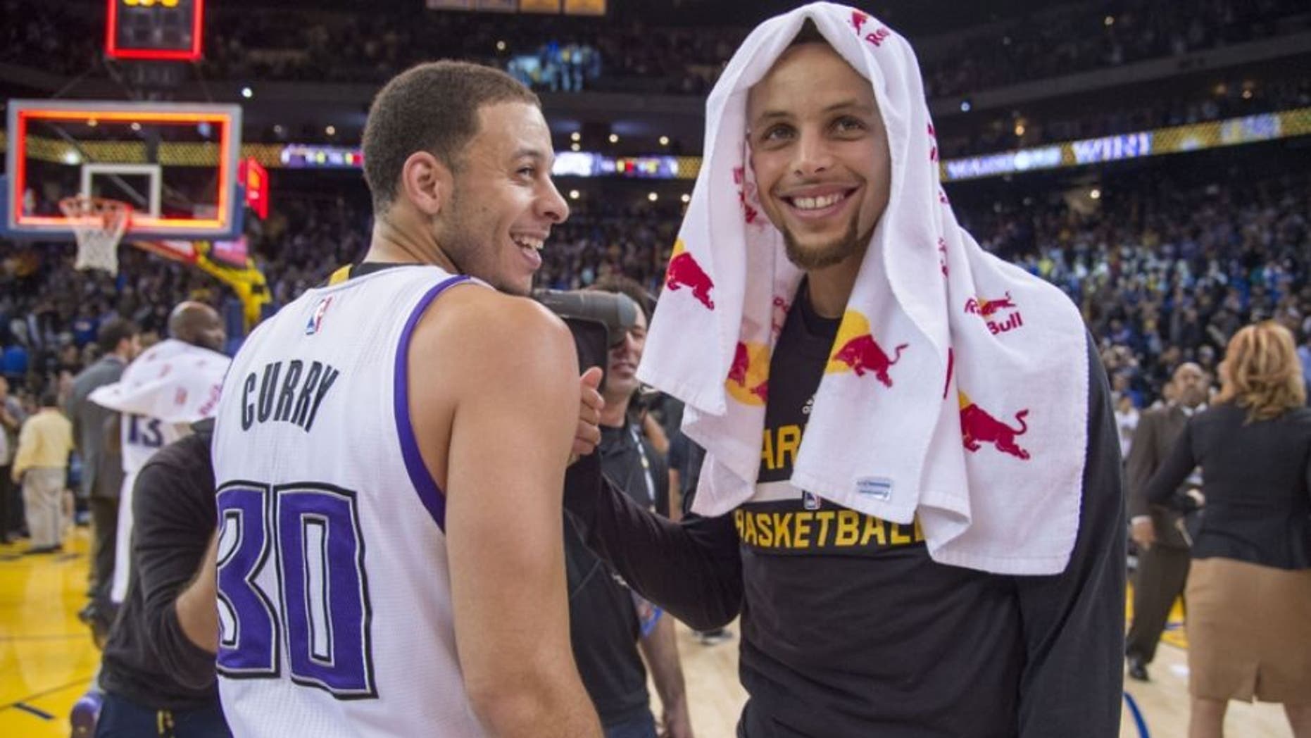November 28, 2015; Oakland, CA, USA; Sacramento Kings guard Seth Curry (30, left) smiles while talking with Golden State Warriors guard Stephen Curry (30, right) after the game at Oracle Arena. The Warriors defeated the Kings 120-101. Mandatory Credit: Kyle Terada-USA TODAY Sports
