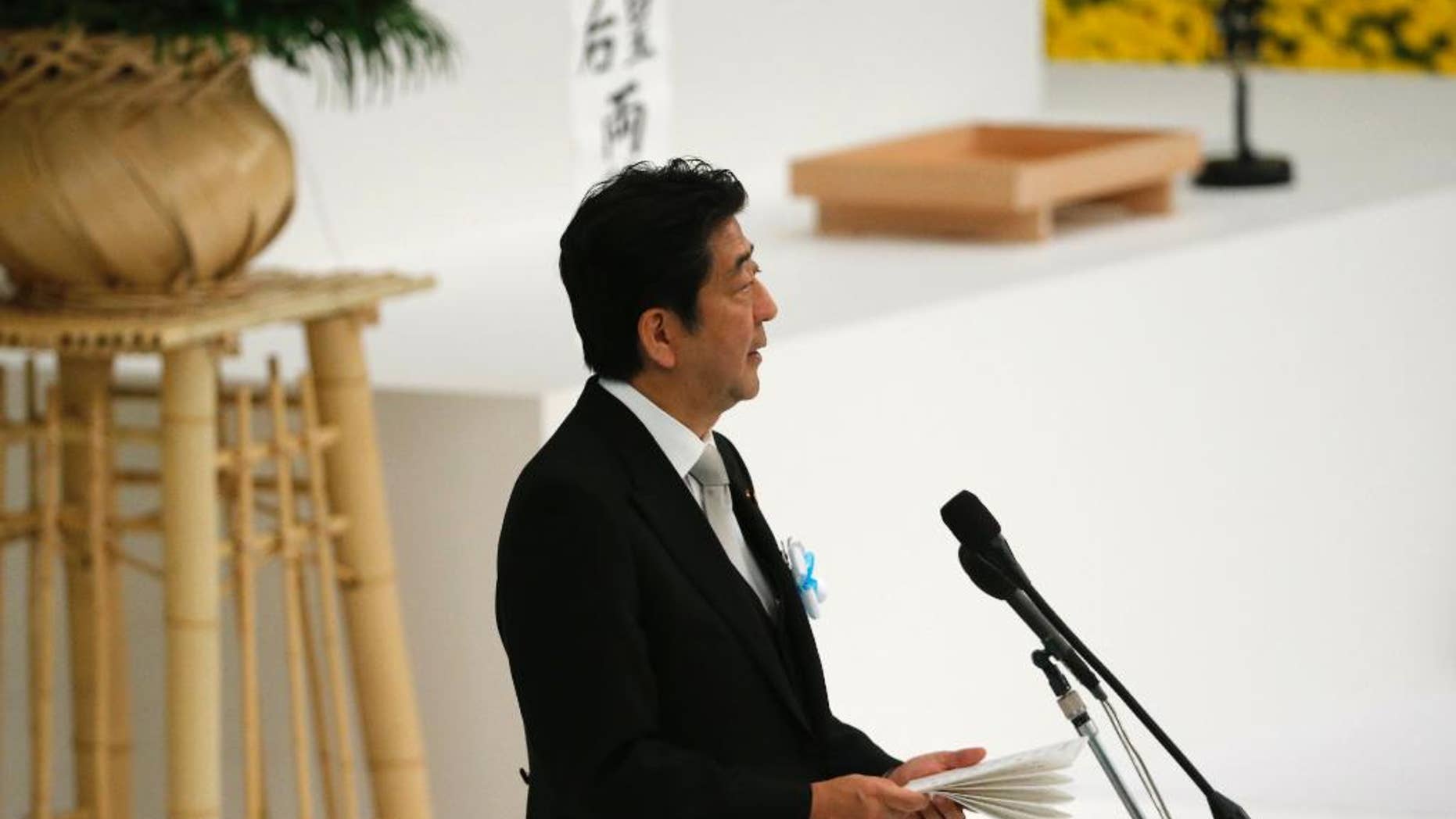 Japan's Prime Minister Shinzo Abe delivers a speech during a national memorial service at the Nippon Budokan martial arts hall in Tokyo Monday.