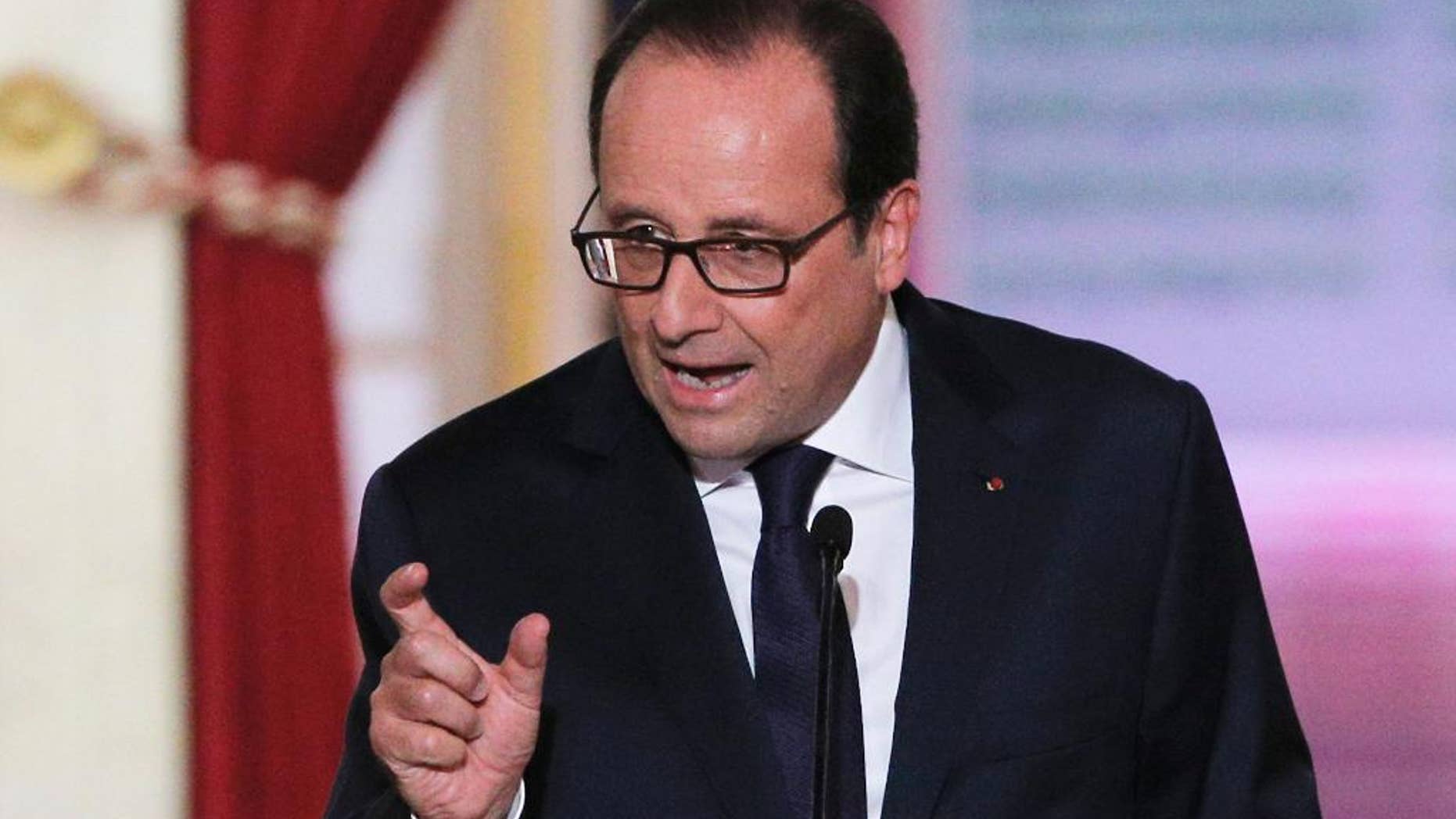 French President Francois Hollande answers reporters after deliver his press conference at the Elysee Palace, Thursday, Sept.18, 2014. Hollande said he agreed to Iraq's request for air support at a meeting of his top defense and security advisers earlier Thursday. (AP Photo/Christophe Ena)