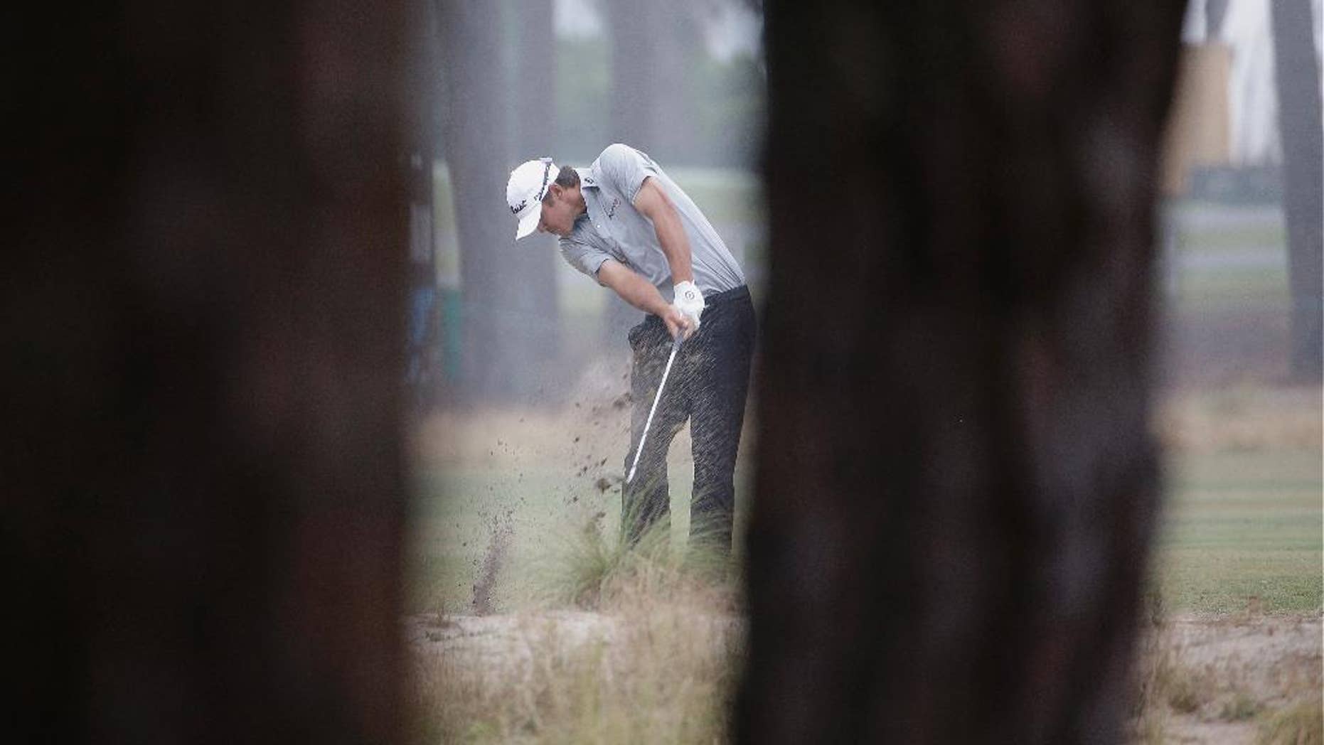 Brooks Koepka hits from the natural area on the 12th hole during the second round of the U.S. Open golf tournament in Pinehurst, N.C., Friday, June 13, 2014. (AP Photo/David Goldman)