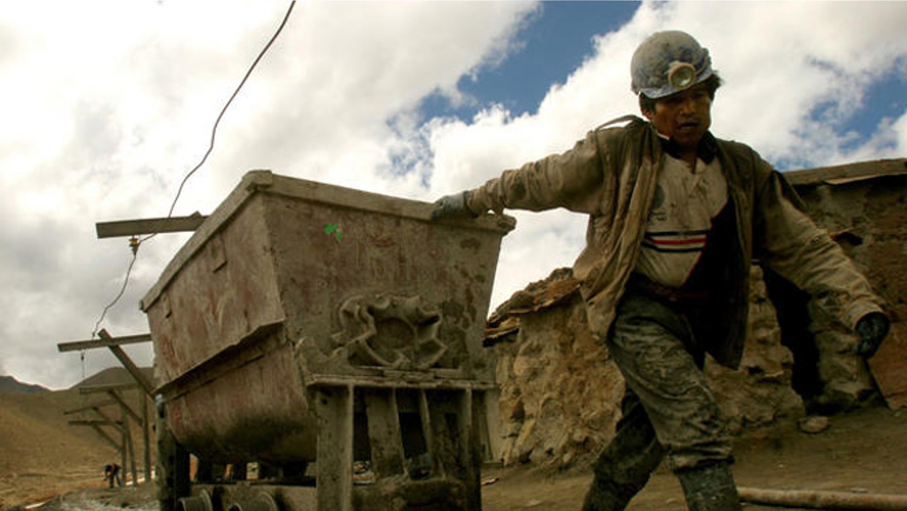 An independent miner leaves the Candelaria zinc-tin mine pulling a two-tons wagon loaded with poorly concentrated mineral at the famous Cerro Rico mountain in Potosi, Bolivia, Feb. 12, 2007. (AP Photo/Dado Galdieri)