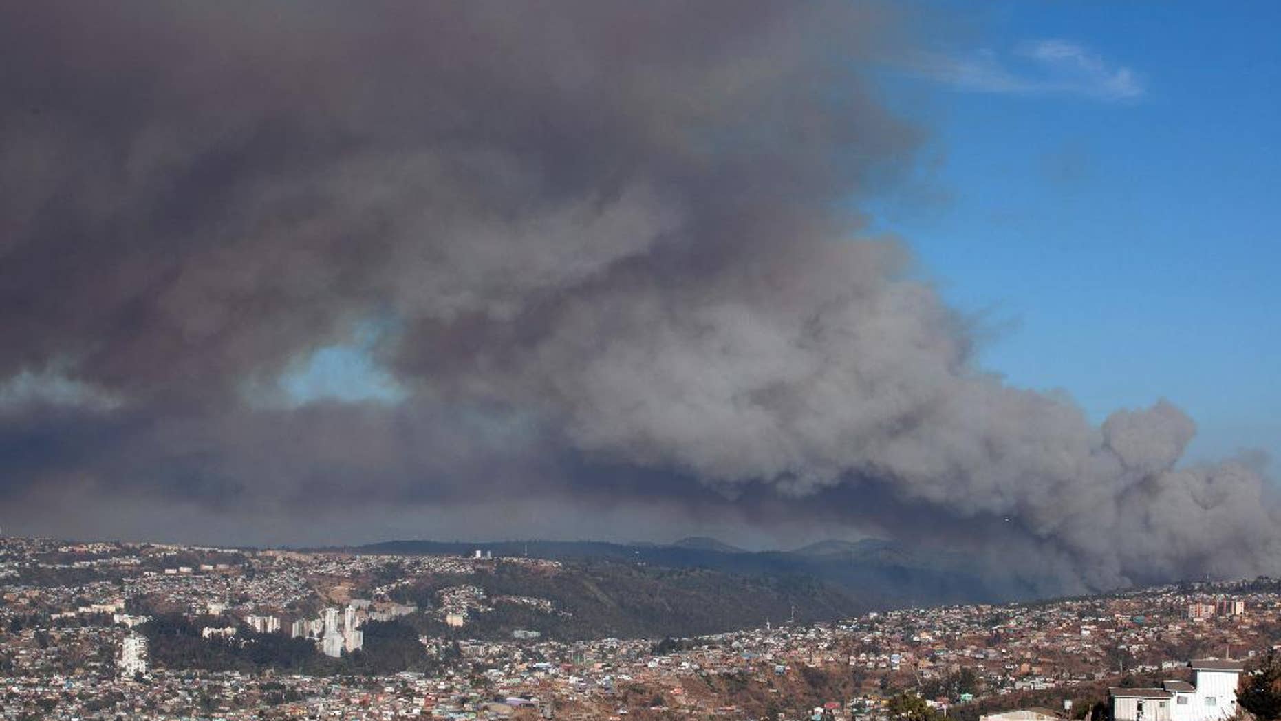Plumes of smoke from a wild fire rise over Valparaiso, Chile, Friday, March 13, 2015. A serious forest fire spread quickly on Chile's coast Friday and threatened to reach the nearby port cities of Valparaiso and Vina del Mar. Deputy Interior Secretary Mahmud Aleuy said that thousands have been evacuated as flames advanced nearby. (AP Photo)