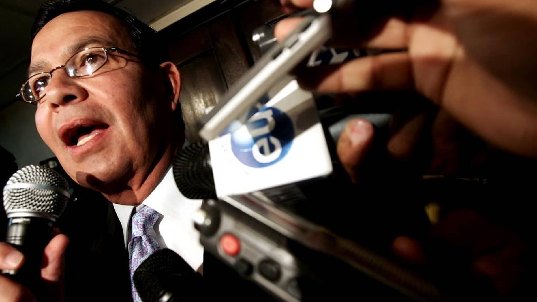 FILE - In this Sep. 20, 2006 file photo, Honduras' former President Rafael Leonardo Callejas speaks to the press in Tegucigalpa, Honduras. Honduras’ foreign minister said on Monday, Dec. 14, 2015 that the ex-president, who also served as president of Honduras' soccer federation, has boarded a private plane with the intention of turning himself in to U.S. authorities investigating corruption and kickbacks in FIFA, soccer's scandal-plagued governing body. The United States had previously requested Callejas’ extradition. (AP Photo/Edgard Garrido, File)