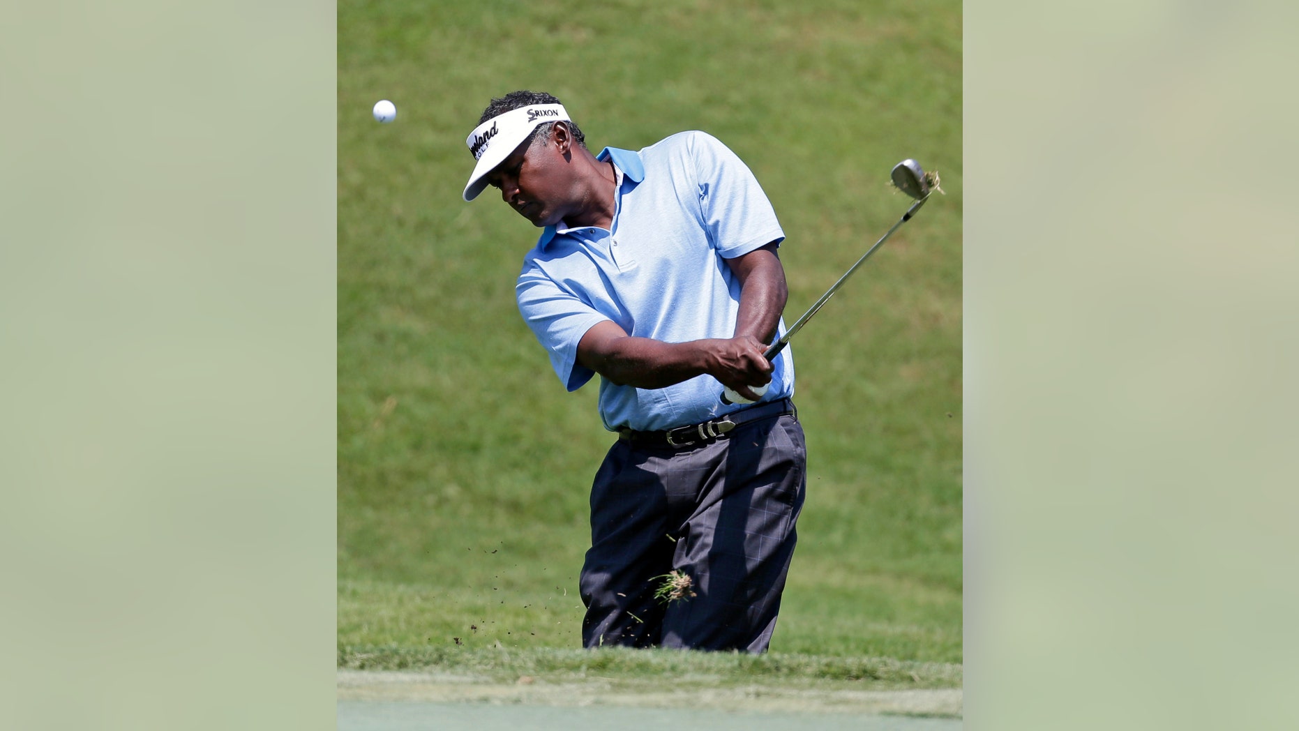 Vijay Singh, from Fiji, chips onto the second green during the first round of The Players championship golf tournament at TPC Sawgrass, Thursday, May 9, 2013, in Ponte Vedra Beach, Fla. (AP Photo/Chris O'Meara)