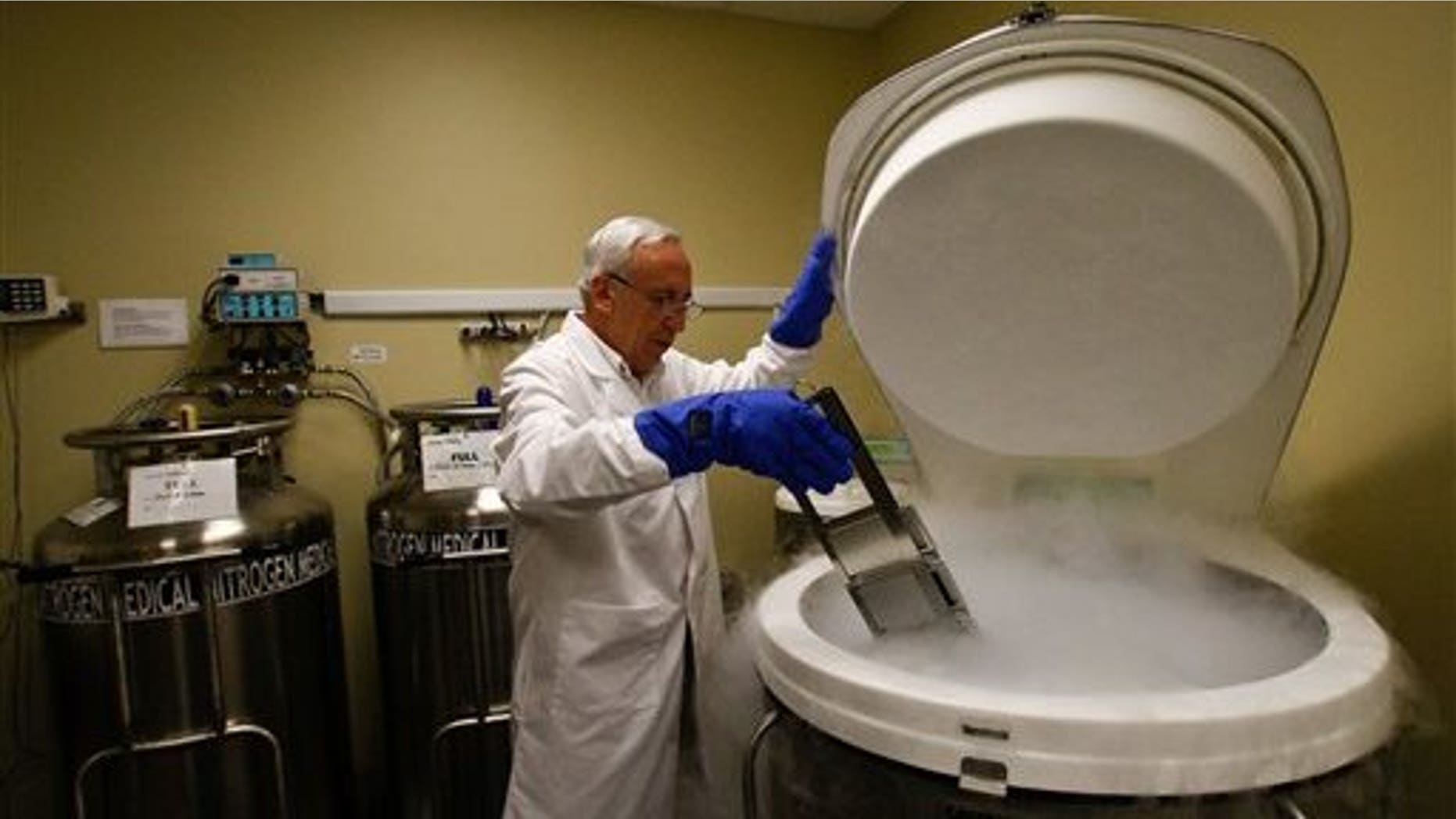 July 26: Scientific Director for TCA Cellular Therapy Jose J. Minguell, inserts samples of stem cells into a cryo storage tank at the Life Source Cryo Bank a subsidiary company of TCA Cellular Therapy L.L.C. in Covington, La. (AP)