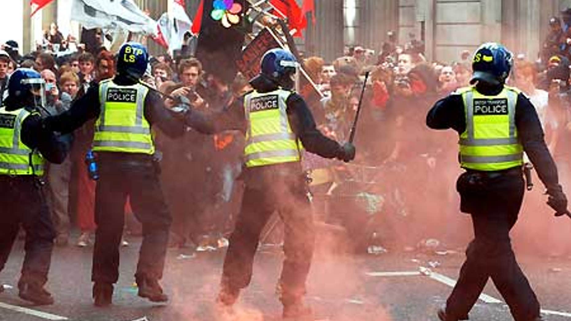 April 1: Riot police confront protesters near the Bank of England in London.