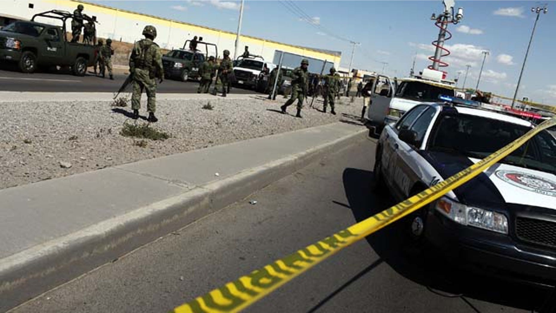 JUAREZ, MEXICO - MARCH 24: Military police keep guard at the site of a murder on March 24, 2010 in Juarez, Mexico. A Pew Research study found that 61 percent of respondents believe the Mexican and United States' governments were equally to blame for explosion in violence the last few years. (Photo by Spencer Platt/Getty Images)