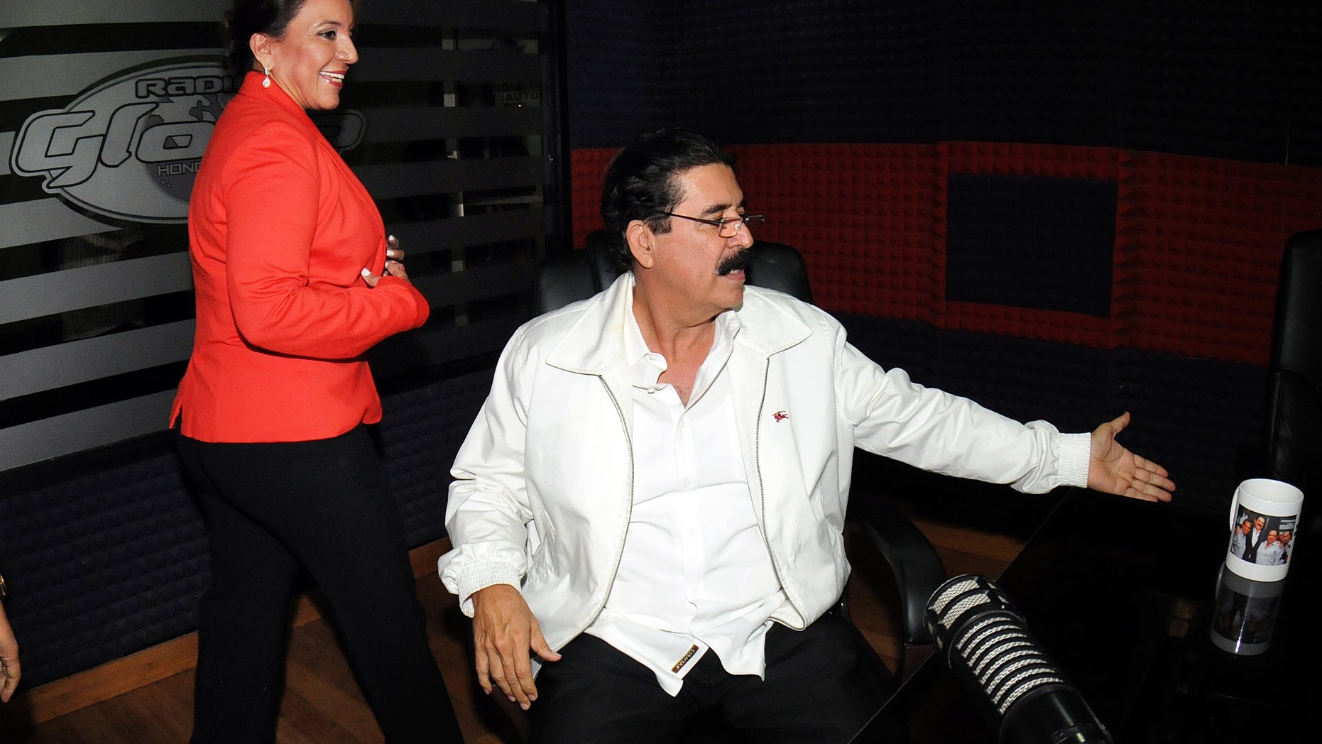 Free Party Presidential candidate Xiomara Castro, left, and her husband, ousted President Manuel Zelaya, arrive for an radio interview in Tegucigalpa, Honduras, Wednesday Nov. 27, 2013. Castro spoke about last Sunday's election results which declared ruling party candidate Juan Orlando Hernandez the winner, saying that there was fraud in the elections and that she will present the evidence Friday. (AP Photo/Fernando Antonio)
