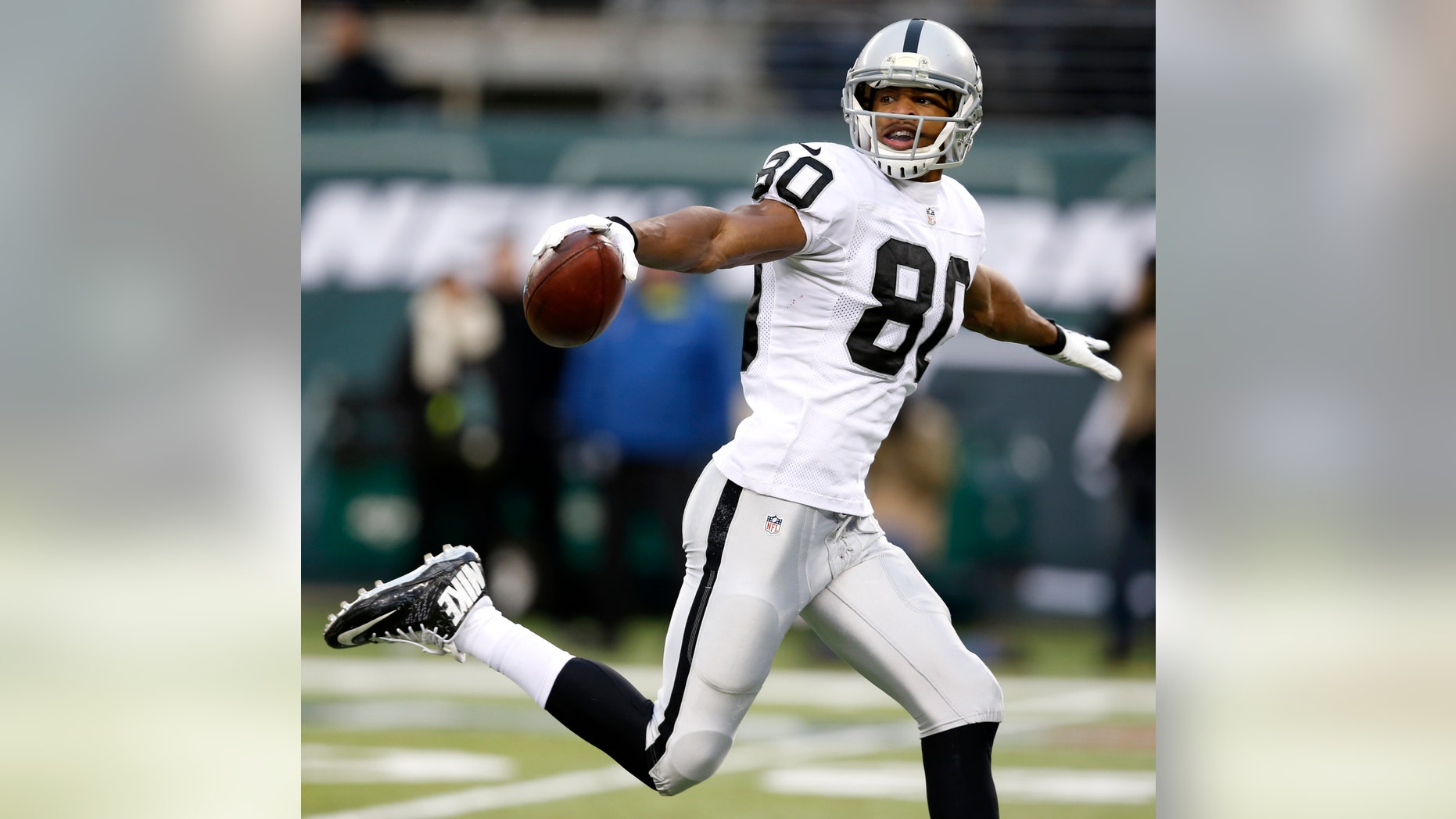 Oakland Raiders wide receiver Rod Streater gestures while scoring on a touchdown catch on a pass from quarterback Matt McGloin during the second half of an NFL football game against the New York Jets, Sunday, Dec. 8, 2013, in East Rutherford, N.J. (AP Photo/Kathy Willens)