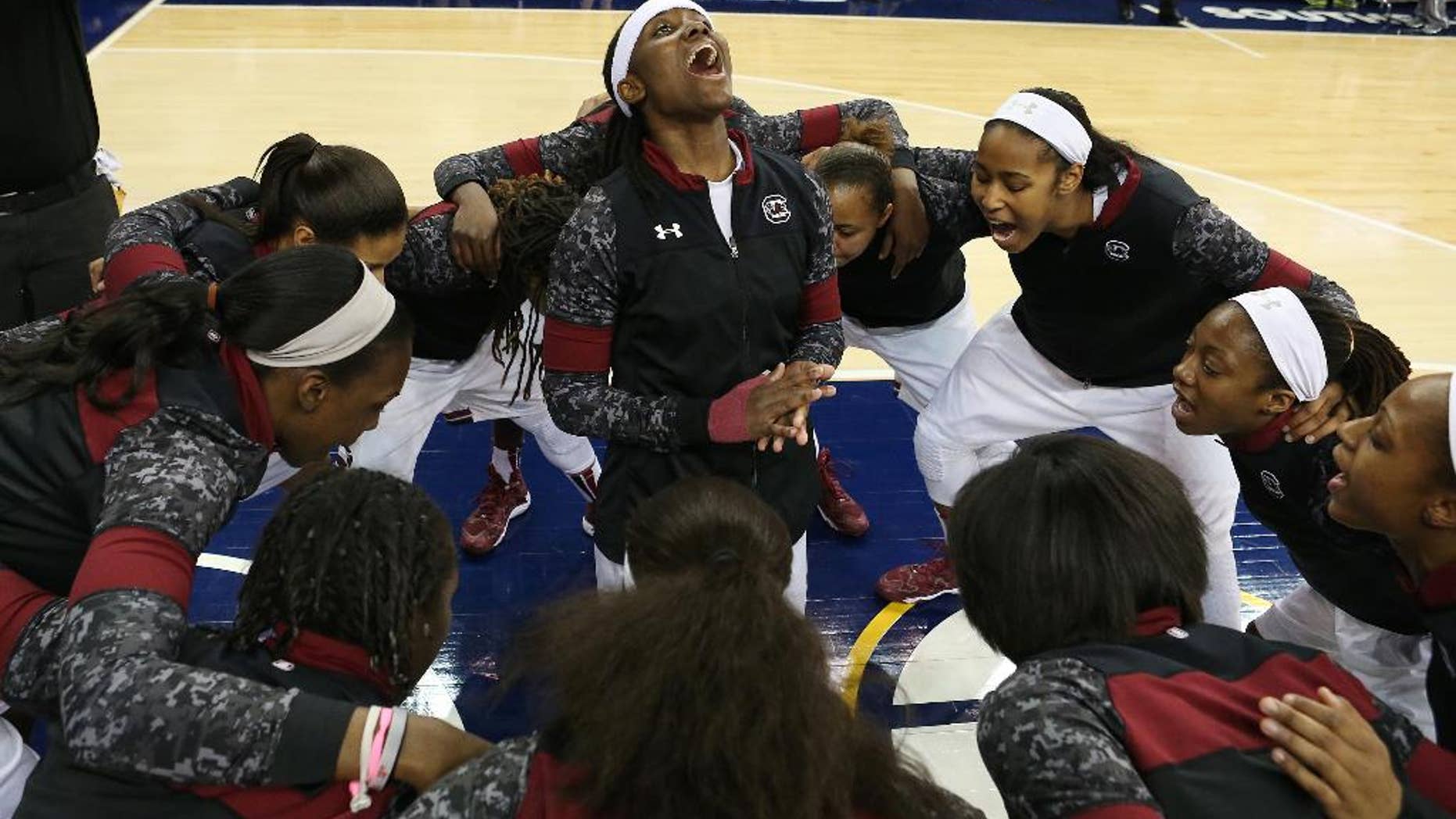South Carolina guard Khadijah Sessions, center, leads her team during a pregame huddle before the start of an NCAA college basketball game against Kentucky in the semifinals of the Southeastern Conference women's basketball tournament Saturday, March 8, 2014, in Duluth, Ga. (AP Photo/Jason Getz)