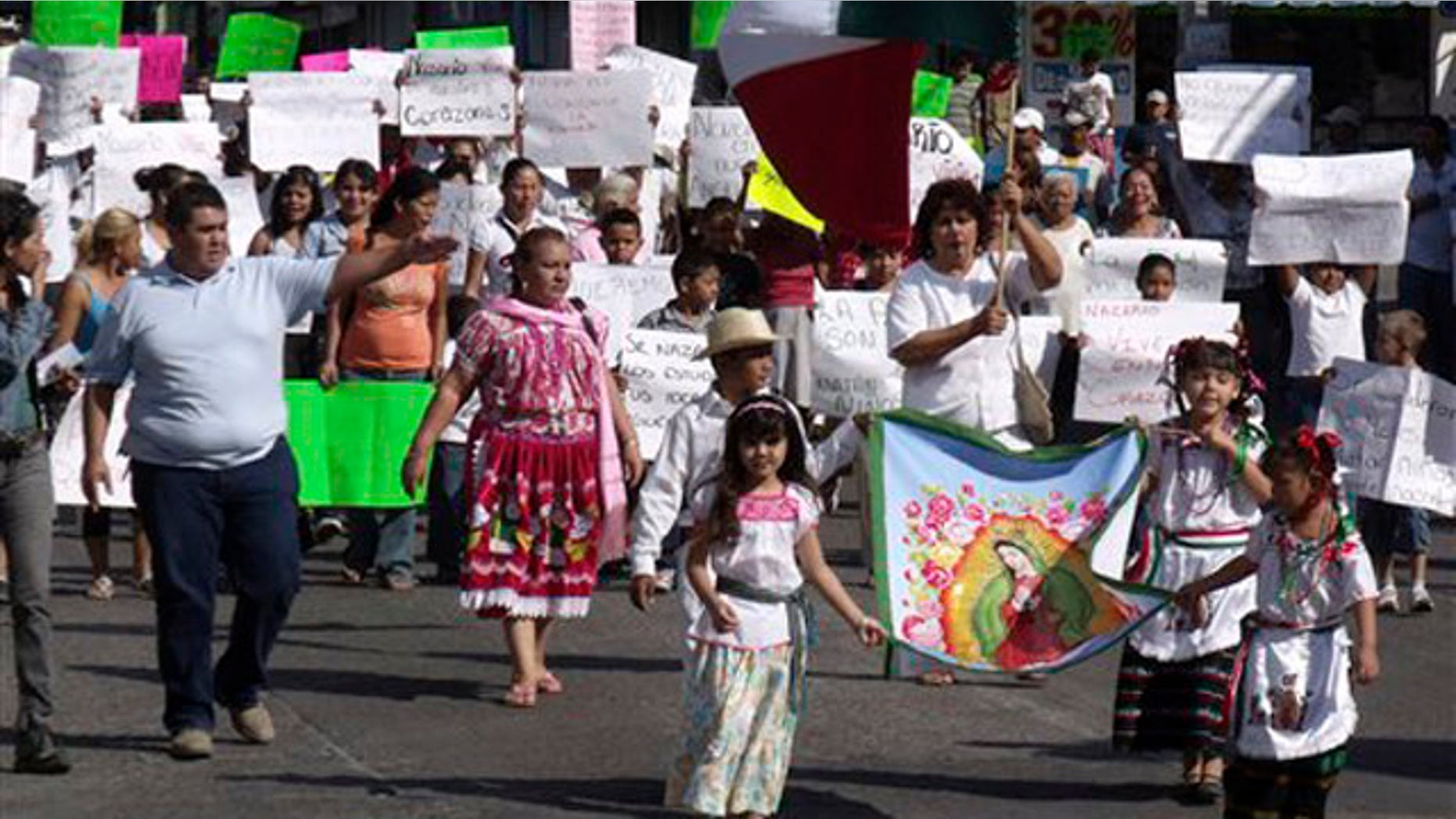People demonstrate in favor of the drug trafficking organization 'La Familia' and its late leader Nazario Moreno Gonzalez in Apatzingan, Mexico, Sunday Dec. 12, 2010. Moreno was killed on Thursday in Apatzingan during two days of shootouts between gunmen and federal police, according to the government.