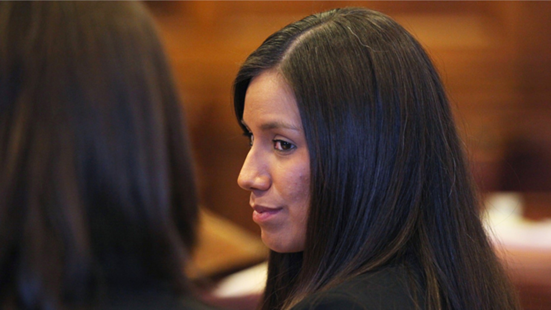 Oct. 9, 2012: Alexis Wright, 29, turns towards her attorney Sarah Churchill, left, during her arraignment in Portland, Maine on 109 counts of prostitution, violation of privacy, tax evasion and other charges for allegedly providing sex for money at her Kennebunk fitness studio and office.