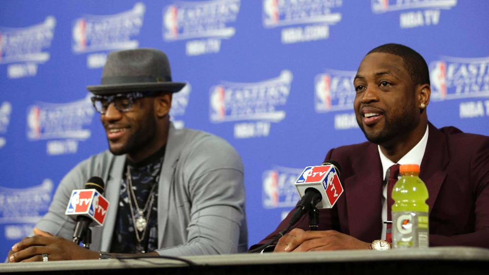 Miami Heat guard Dwyane Wade, right, and forward LeBron James speak during a news conference following Game 3 in the NBA basketball Eastern Conference finals playoff series against the Indiana Pacesr, Saturday, May 24, 2014, in Miami. The Heat defeated the Pacers 99-87. (AP Photo/Lynne Sladky)