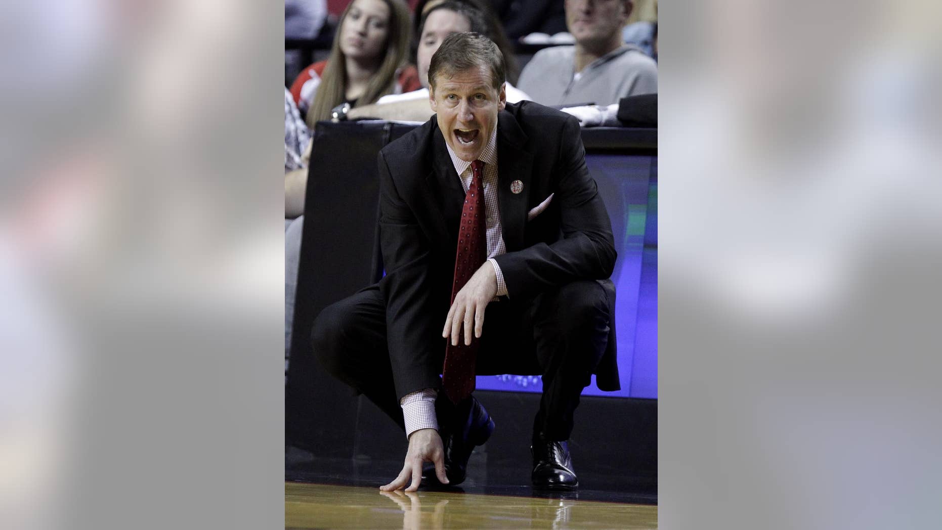 Portland Trail Blazers coach Terry Stotts calls out from the bench area during the second half of an NBA preseason basketball game against Maccabi Haifa in Portland, Ore., Friday, Oct. 17, 2014. The entire Portland roster of 17 players scored as the Blazers won 121-74. (AP Photo/Don Ryan)