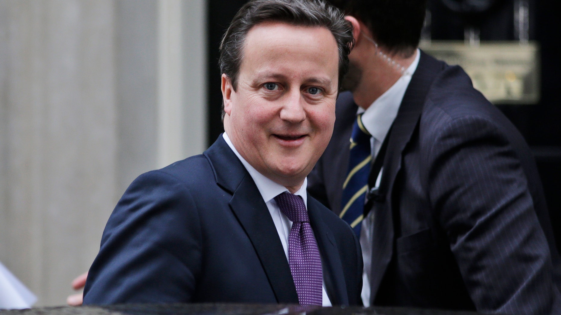 Britain's Prime Minister David Cameron leaves his official residence at 10 Downing Street in central London, on his way to the Houses of Parliament to address lawmakers, Wednesday, Jan. 30, 2013. Cameron will travel to Algeria for bilateral meetings Wednesday in wake of the hostage crisis at a natural gas plant in the north African country.The Jan. 16 attack on Algeria's Ain Amenas gas plant ignited a four-day siege with Algerian forces in which at least 37 hostages and 29 militants were killed. Three Britons are confirmed to have died in the attack, and another three are believed dead. (AP Photo/Lefteris Pitarakis)