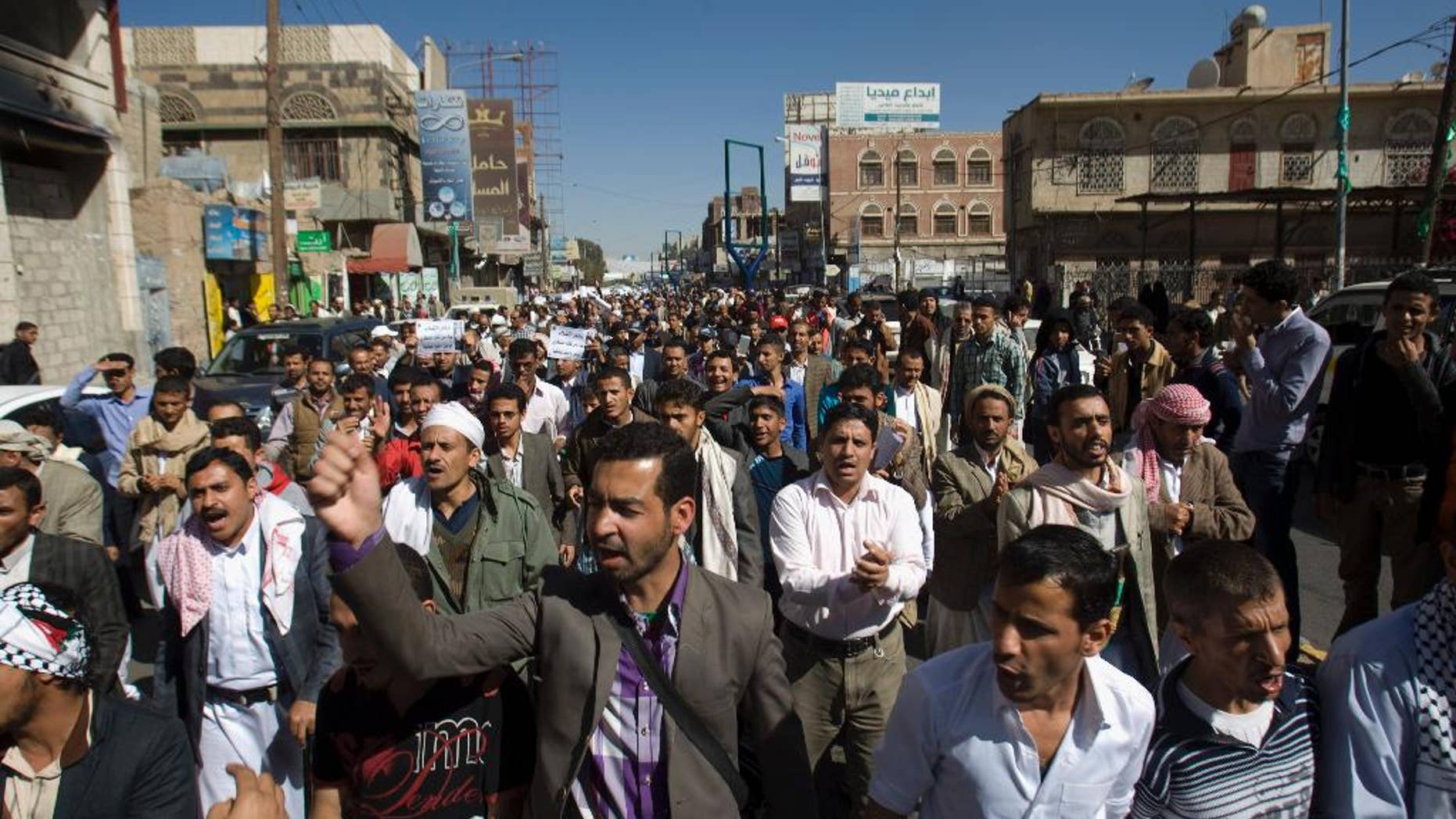 FILE - In this Saturday, Jan. 24, 2015 file photo, protesters chant slogans against Houthi Shiite rebels who hold the capital, Sanna, amid a power vacuum as they march on a street in Sanaa. A U.S. drone strike targeting al-Qaida in Yemen signals Washington’s determination to keep fighting the militants despite political paralysis brought on by the minority Shiite power grab. But officials say an effective ground strategy to truly uproot the militants will have to await the emergence of a functioning local government that can act as an ally. (AP Photo/Hani Mohammed, File)