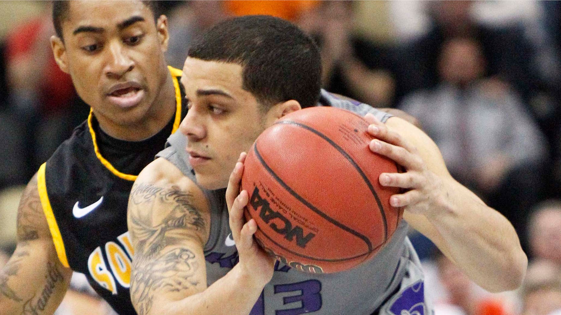 Kansas State's Angel Rodriguez (13) gets control of a loose ball in front of Southern Mississippi's Neil Watson, left, defends in the first half of an East Regional NCAA tournament second-round college basketball game on Thursday, March 15, 2012, in Pittsburgh.