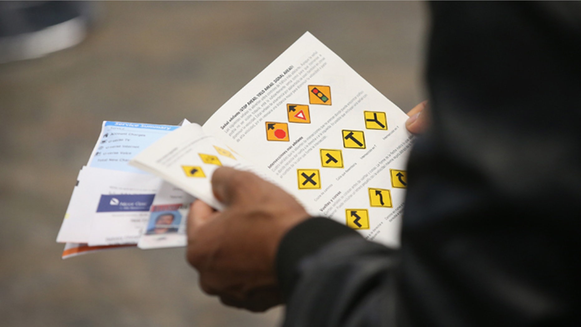 CHICAGO, IL - DECEMBER 10: An Illinois resident uses a Spanish-language study guide to prepare for his driver's license exam at a driver services facility on December 10, 2013 in Chicago, Illinois. Illinois recently began a Temporary Visitors Driver's License (TVDL) program which allows undocumented immigrants to obtain a driver's license. The applicants must have an Illinois address, prove 12 months of residency in the state, and have a valid passport or consular card to be eligible. (Photo by Scott Olson/Getty Images)