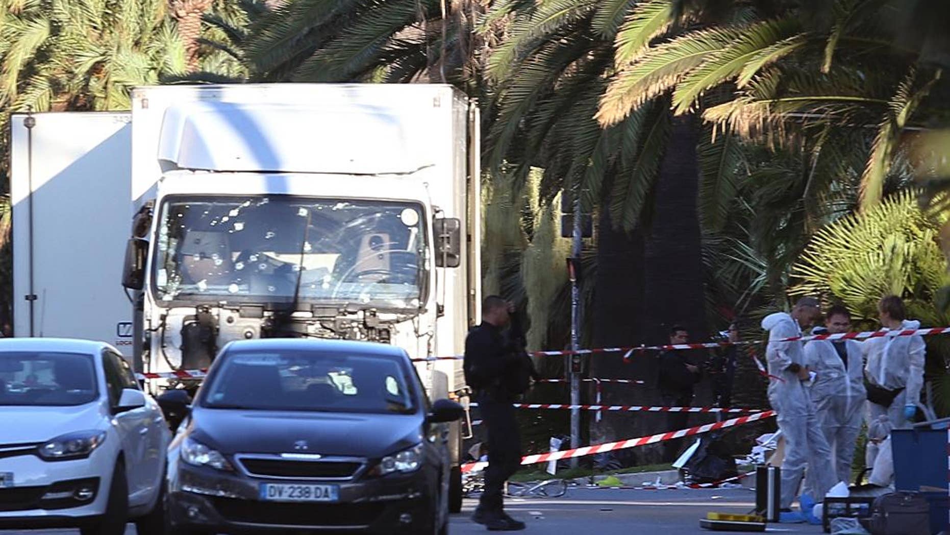 The truck which slammed into revelers late Thursday, July 14, is seen near the site of an attack in the French resort city of Nice, southern France, Friday, July 15, 2016. France has been stunned again as a large white truck mowed through a crowd of revelers gathered for a Bastille Day fireworks display in the Riviera city of Nice. (AP Photo/Luca Bruno)