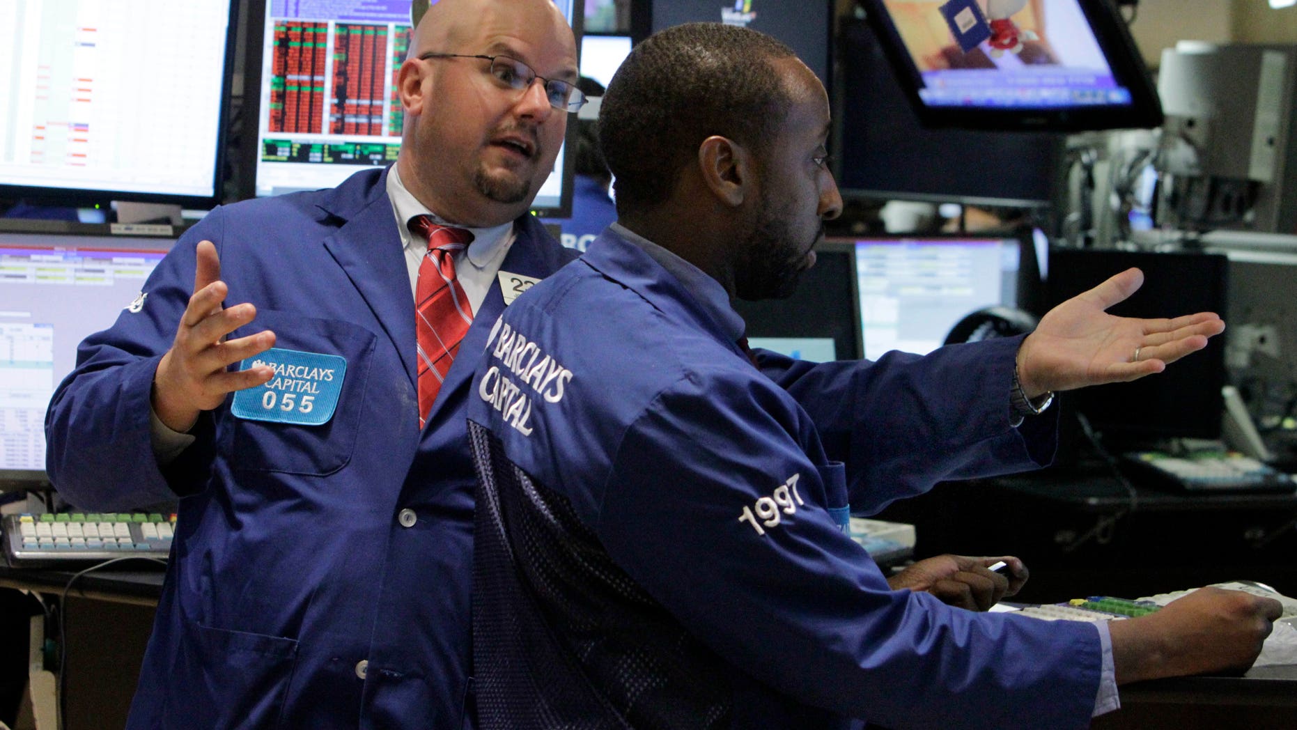 In this Aug. 11, 2010 photo, specialist John Urbanowicz, left, talks with a colleague on the floor of the New York Stock Exchange. Stocks are opening Wednesday, May 22, 2013, slightly higher as investors watch for the latest moves from the Federal Reserve. (AP Photo/Richard Drew)