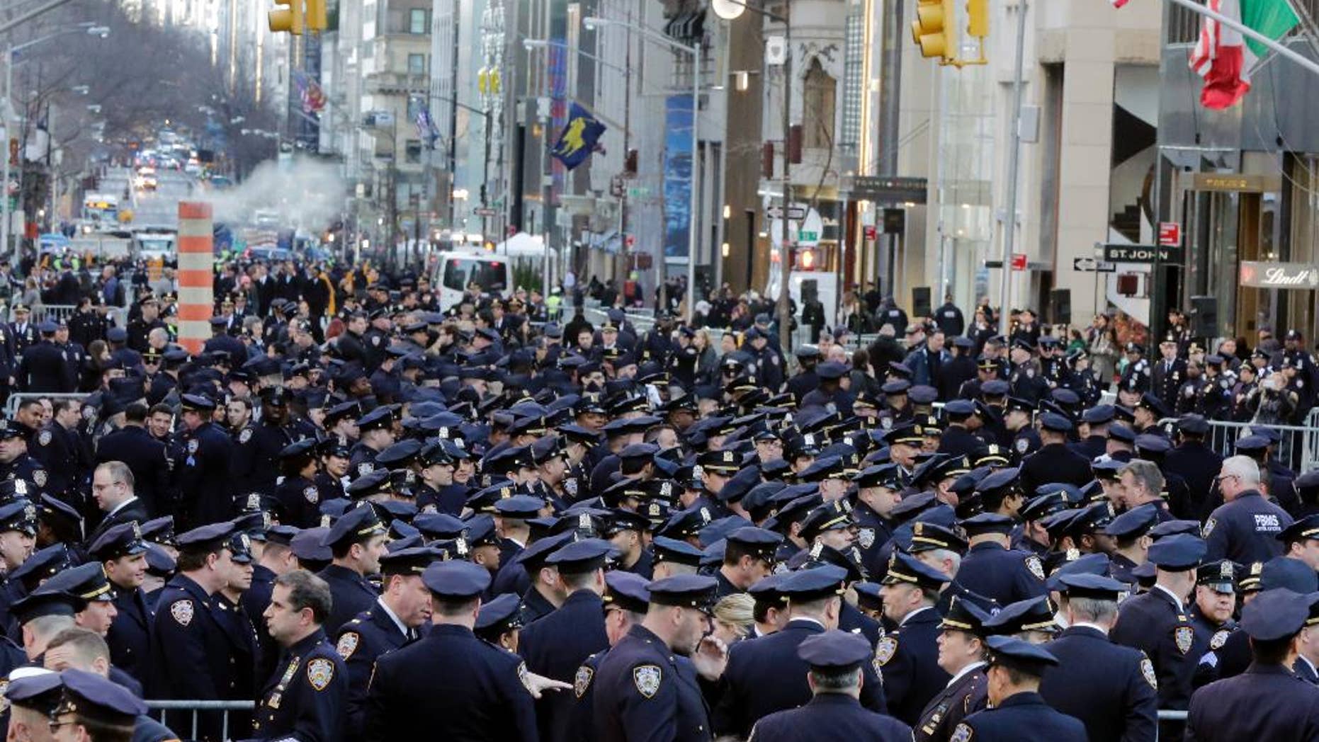 Police officers fill New York's Fifth Avenue ahead of the funeral.