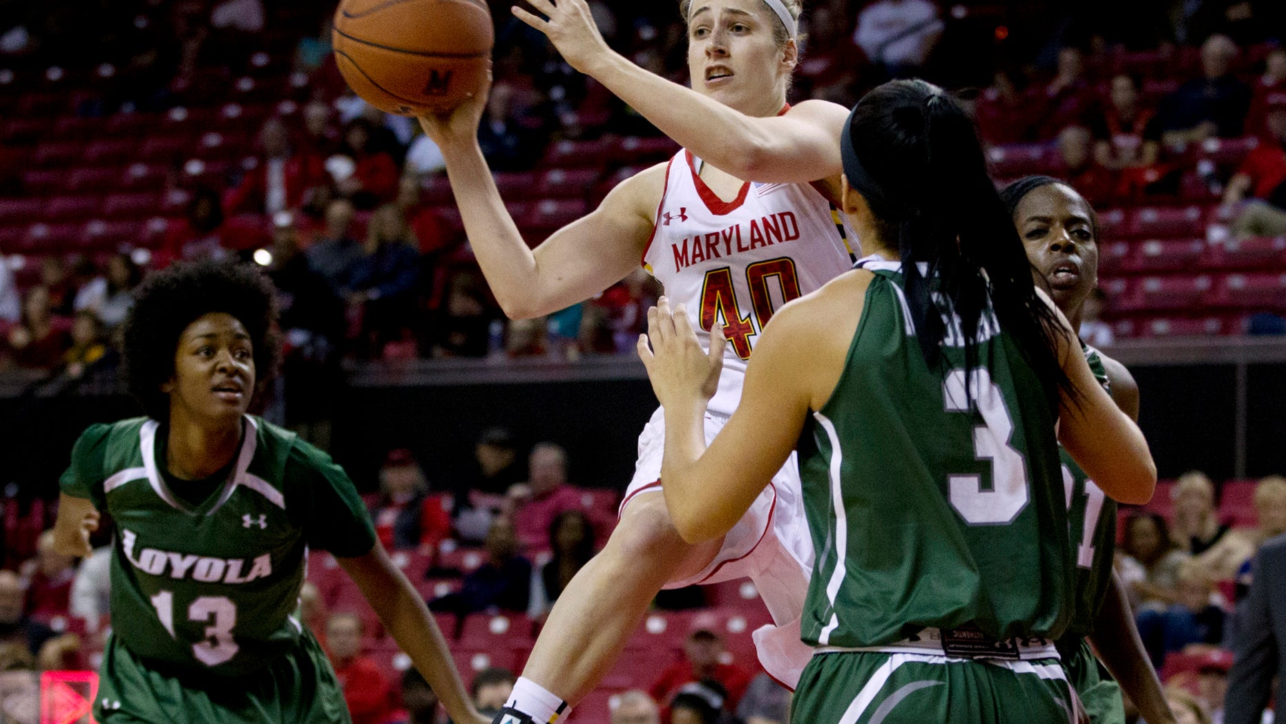 Maryland's Katie Rutan (40) passes the ball during the first half of an NCAA college basketball game against Loyola in College Park, Md., Sunday, Nov. 10, 2013. (AP Photo/Jose Luis Magana)