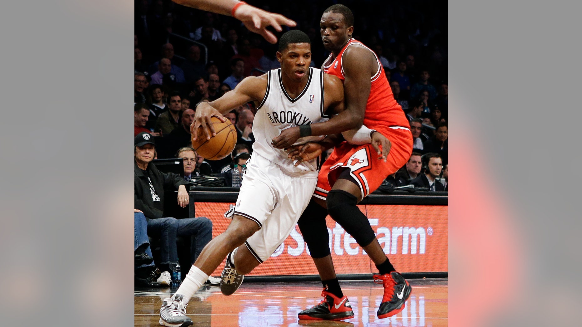 Brooklyn Nets guard Joe Johnson, left, tries to drive past Chicago Bulls forward Luol Deng in the first half of Game 2 of their first-round NBA basketball playoff series, Monday, April 22, 2013, in New York. (AP Photo/Kathy Willens)