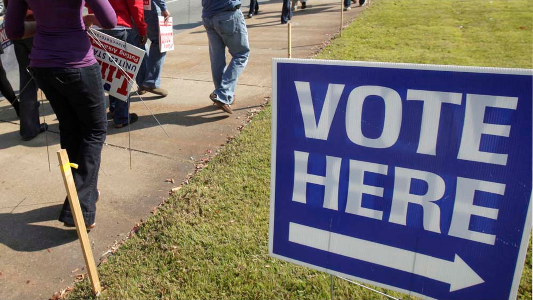 Campaign workers and volunteers walks past an early voting polling place in Little Rock, Ark., Monday, Oct. 18, 2010. (AP Photo/Danny Johnston)