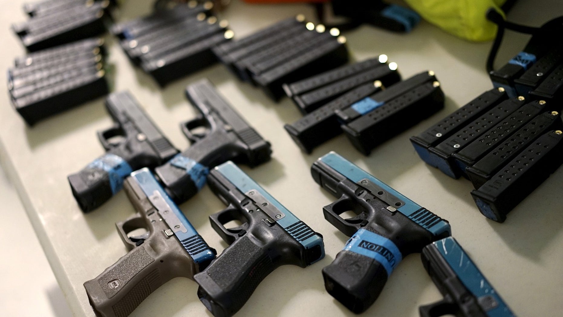 Some Glock semi-automatic pistols and non-lethal training ammunition are seen in Denver, April 2, 2016.