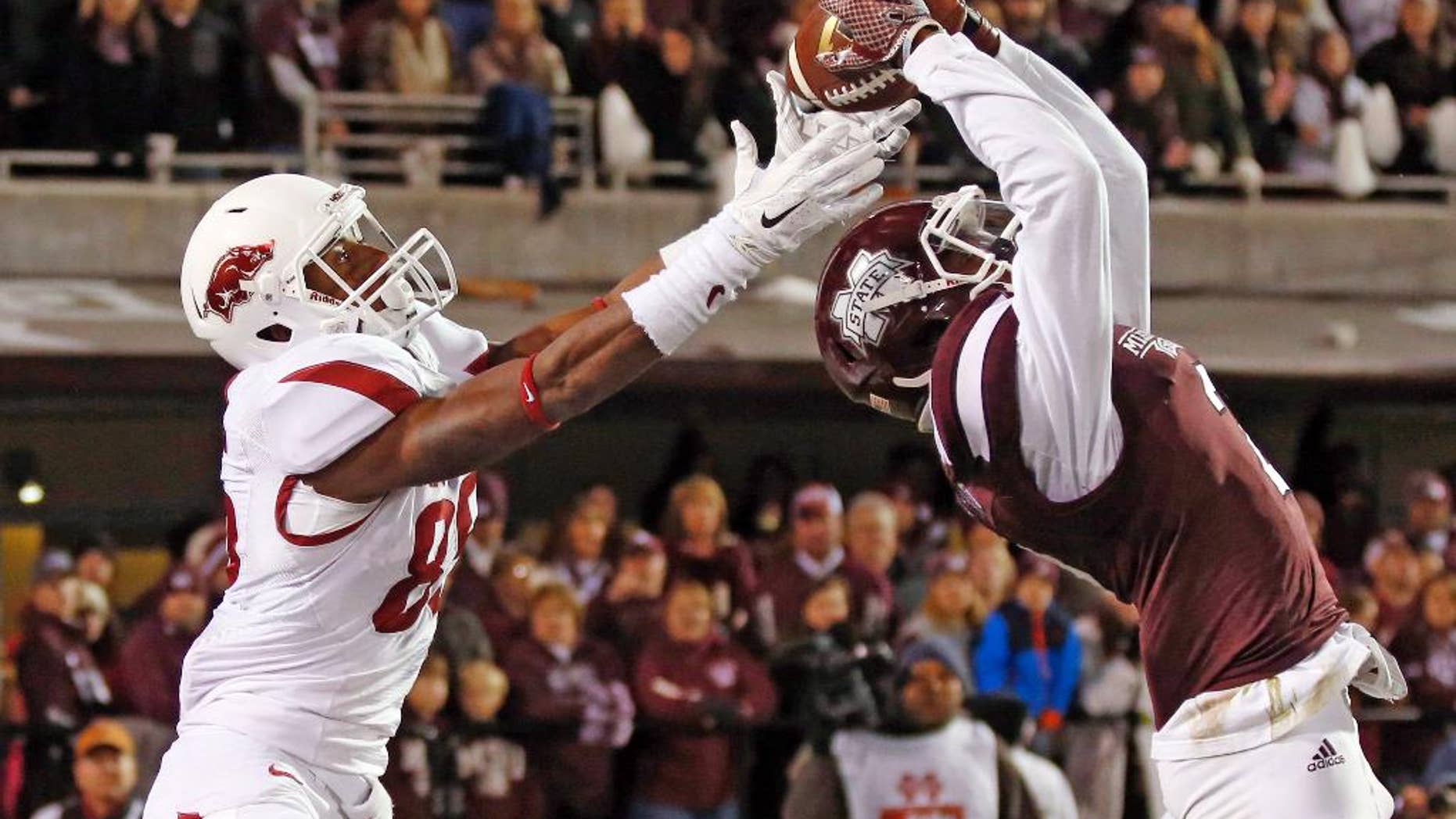 Mississippi State defensive back Will Redmond (2) reaches to intercept a pass intended for Arkansas wide receiver Demetrius Wilson (85) in the end zone in the final seconds of the second half of an NCAA college football game in Starkville, Miss., Saturday, Nov. 1, 2014. No. 1 Mississippi State won 17-10. (AP Photo/Rogelio V. Solis)