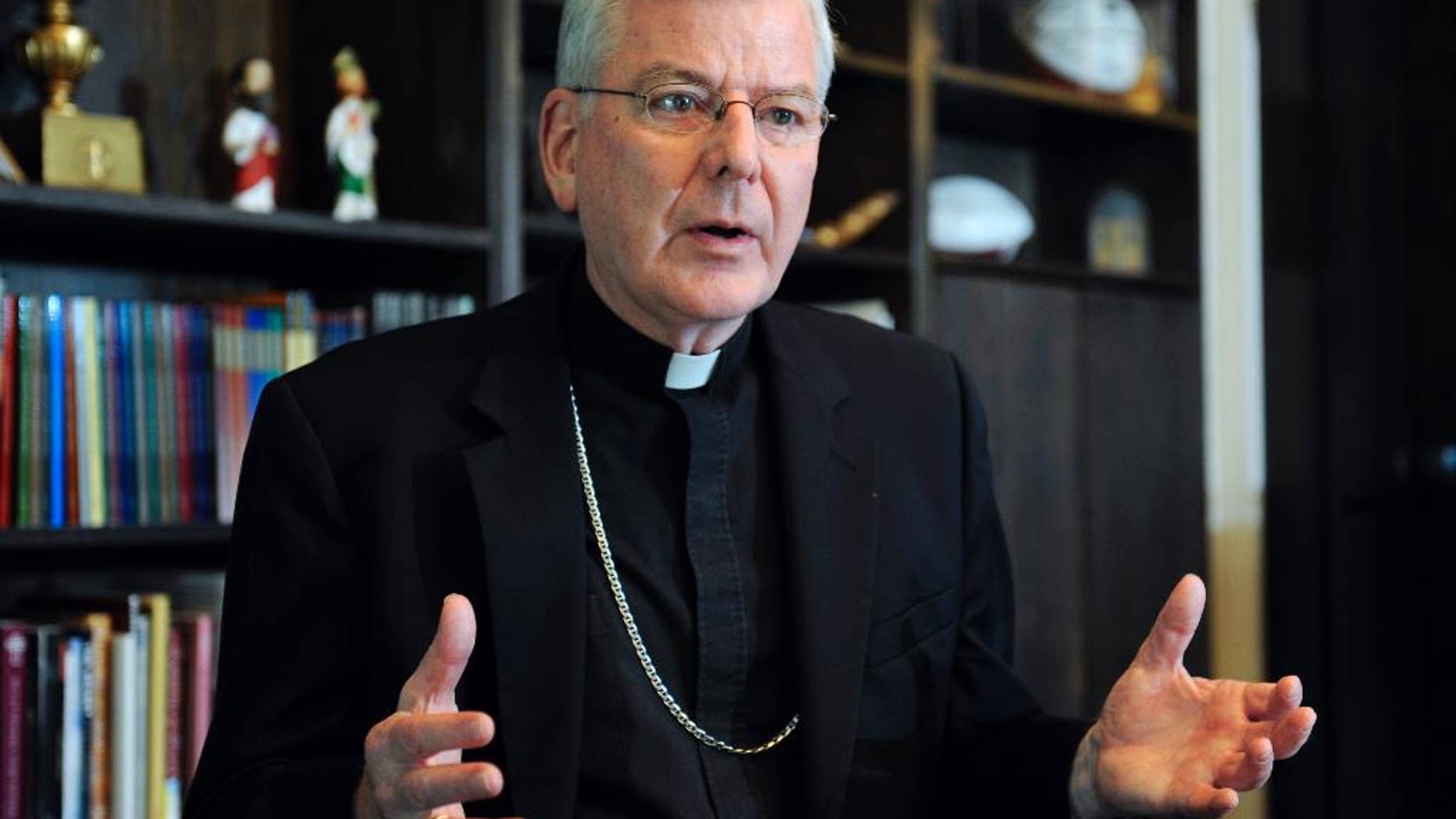 FILE - In this July 30, 2014, file photo, St. Paul-Minneapolis Archbishop John Nienstedt speaks at his office in St. Paul, Minn. On Monday, June 15, 2015, the Vatican said Pope Francis accepted the resignations of Nienstedt and Auxiliary Bishop Lee Anthony Piche after prosecutors charged the archdiocese with having failed to protect children from unspeakable harm from a pedophile priest. Nienstedt, interfered with an investigation by an outside law firm into allegations of his misconduct, Minnesota Public Radio reported Friday, June 19, 2015. (AP Photo/Craig Lassig, File)